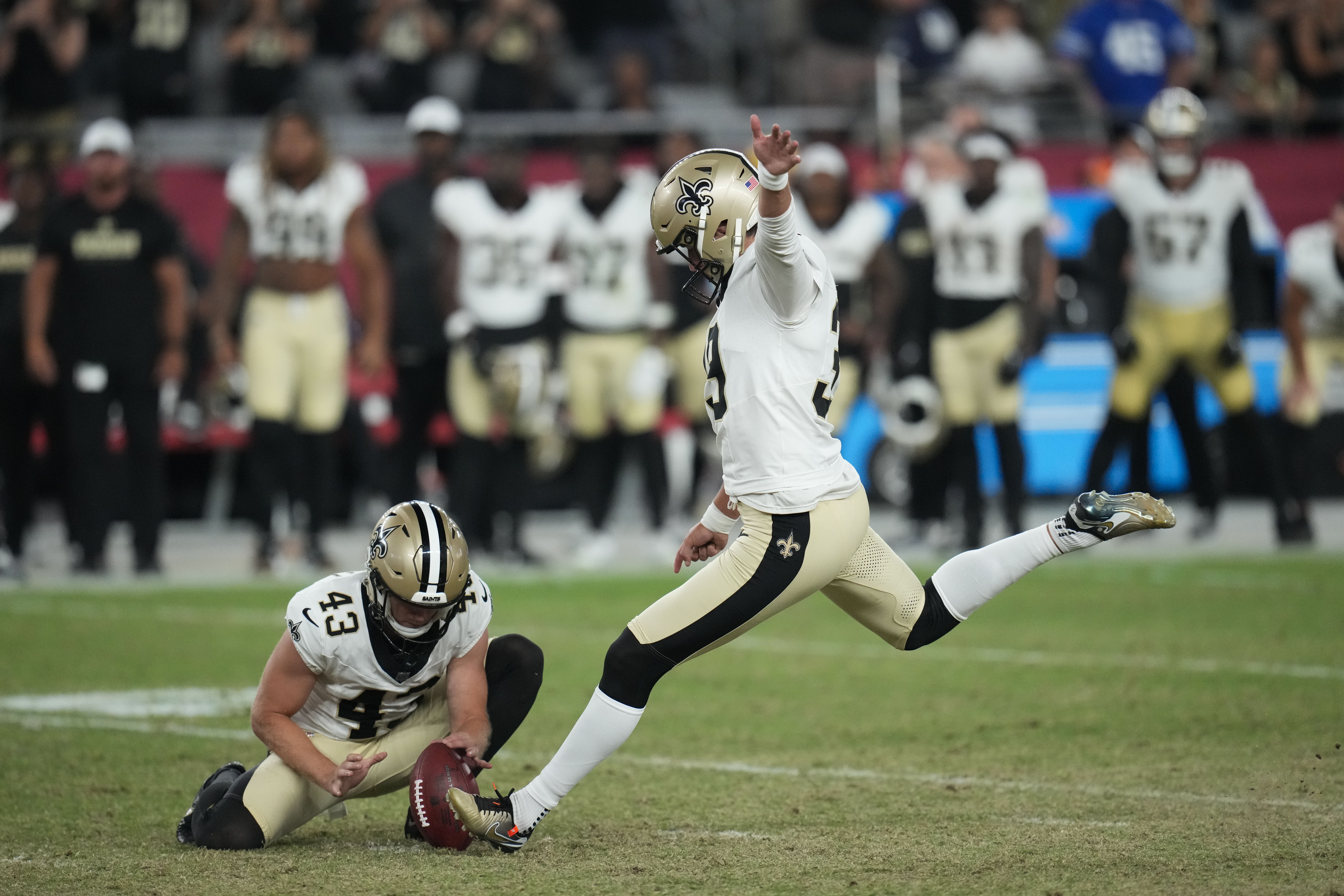 New Orleans Saints place kicker Charlie Smyth kicks the game winning field goal as Matthew Hayball (43) holds, in the second half of a preseason NFL football game against the Arizona Cardinals, Saturday, Aug. 10, 2024, in Glendale, Ariz. The Saints won 16-14. 
