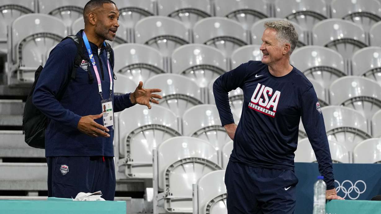 United States men's basketball coach Steve Kerr, right, talks with Grant Hill, Team USA's managing director as the United State's men's team practiced before the start of the basketball competition at the 2024 Summer Olympics, Wednesday, July 24, 2024 in Villeneuve-d'Ascq, France.