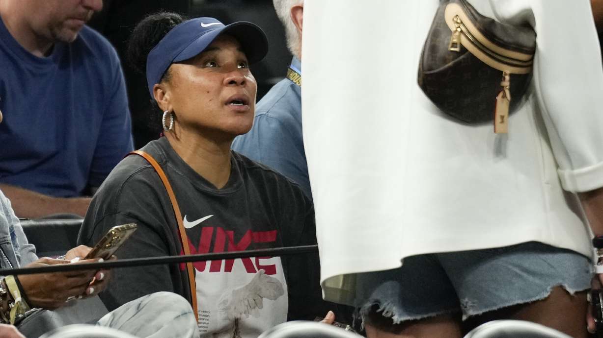 Dawn Staley speaks to a passer by during the game between France and United States during a men's gold medal basketball game at Bercy Arena at the 2024 Summer Olympics, Saturday, Aug. 10, 2024, in Paris, France.