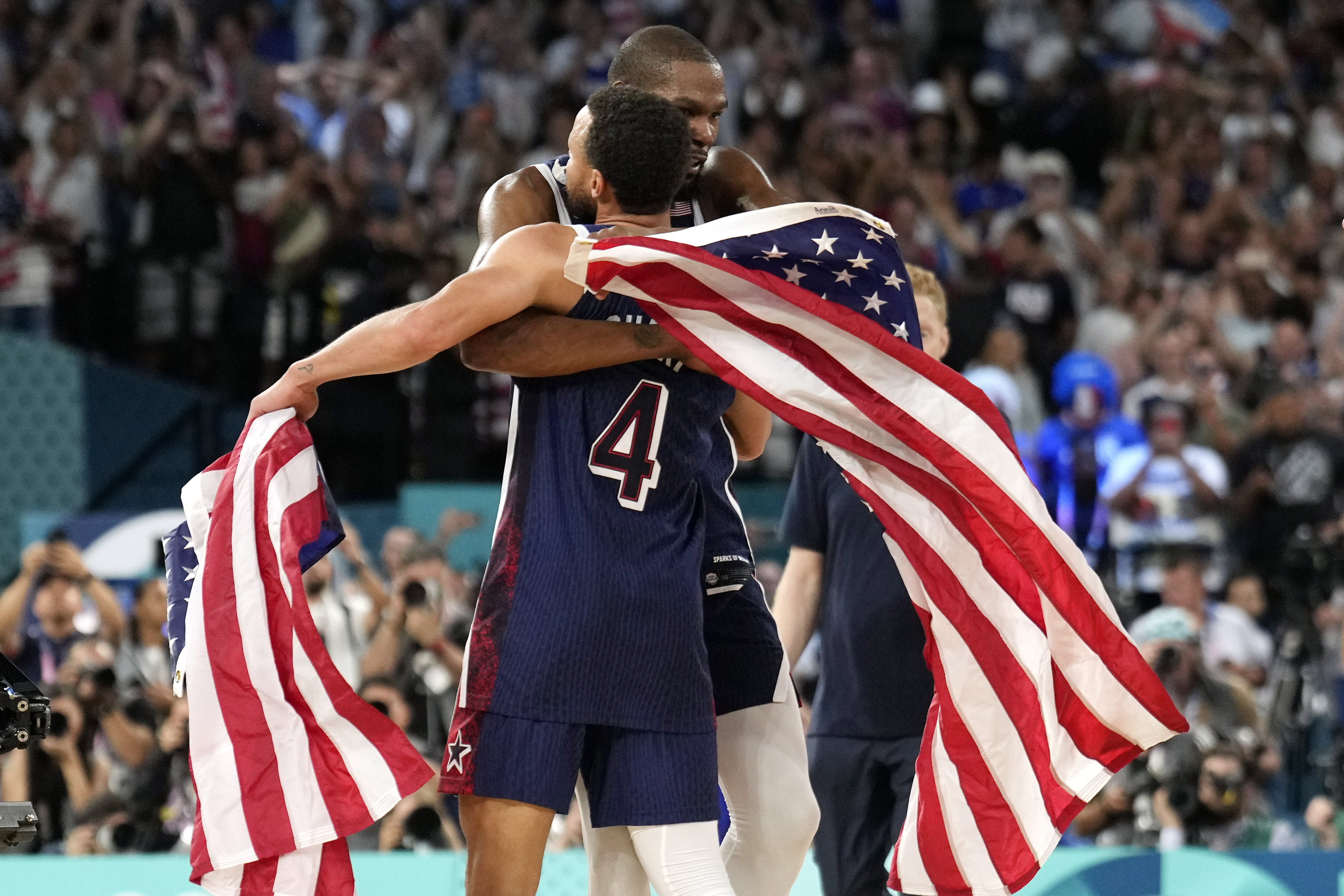 United States' Stephen Curry, left, and United States' Kevin Durant hug after the the United States won the men's gold medal basketball game at Bercy Arena at the 2024 Summer Olympics, Saturday, Aug. 10, 2024, in Paris, France. 