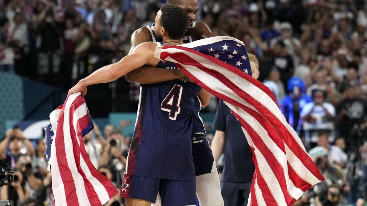 United States' Stephen Curry, left, and United States' Kevin Durant hug after the the United States won the men's gold medal basketball game at Bercy Arena at the 2024 Summer Olympics, Saturday, Aug. 10, 2024, in Paris, France.