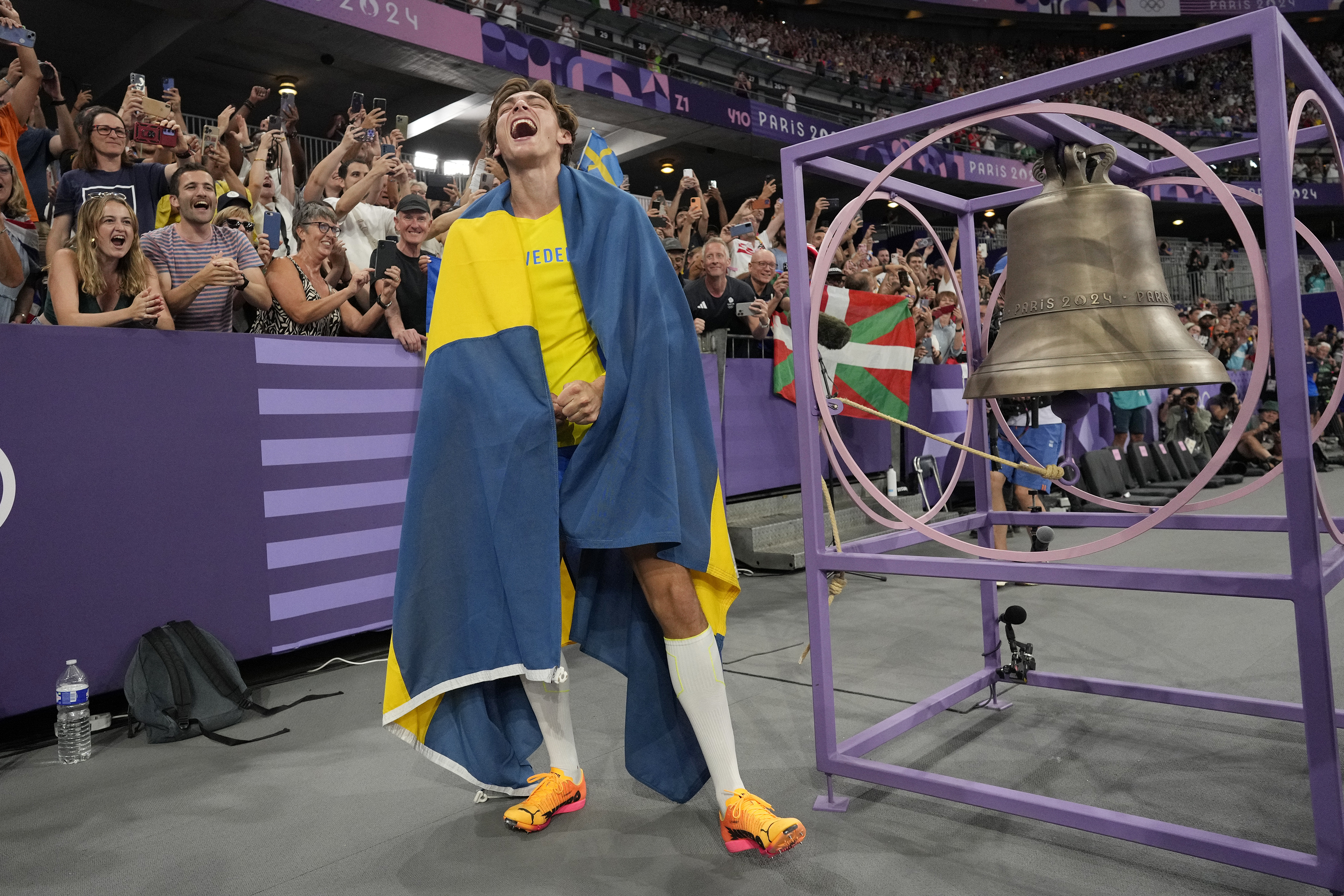 Armand Duplantis, of Sweden, reacts after setting a new world record in the men's pole vault final at the 2024 Summer Olympics, Monday, Aug. 5, 2024, in Saint-Denis, France. 