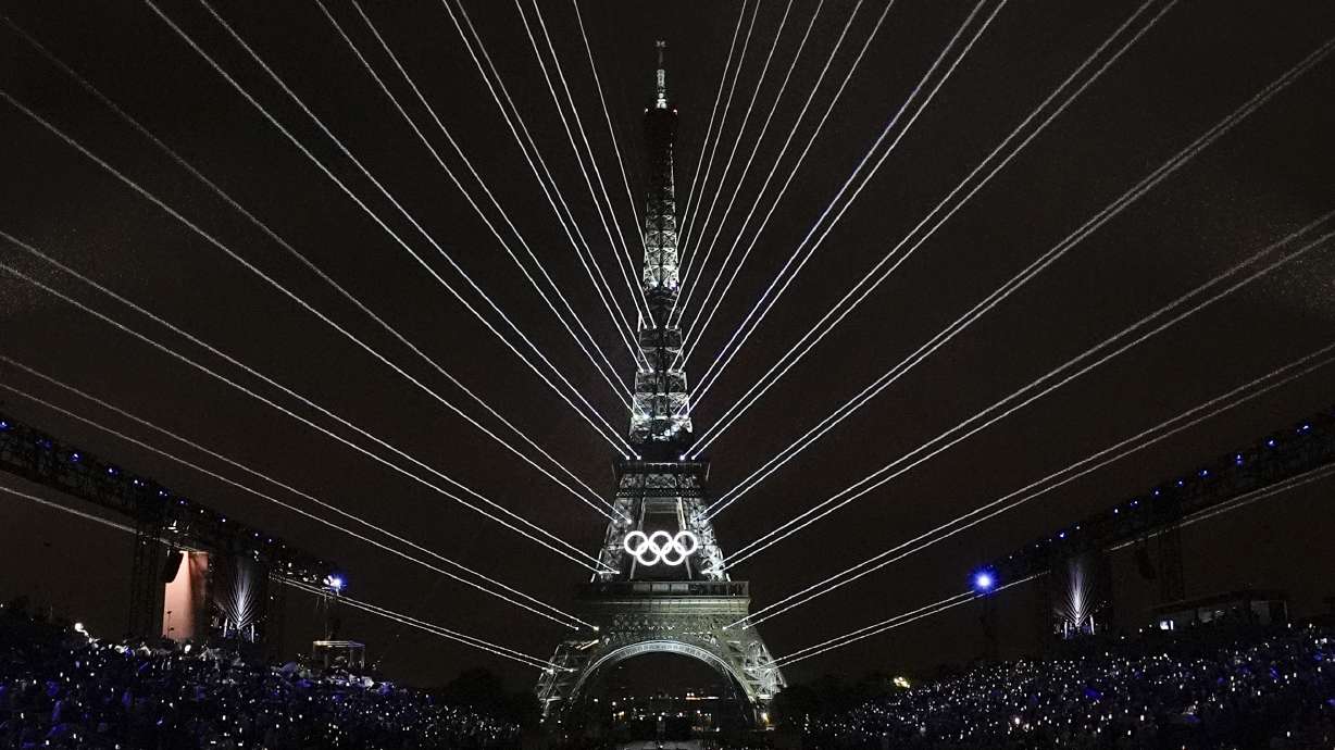 A light show is projected from the Eiffel Tower in Paris, France, during the opening ceremony of the 2024 Summer Olympics, Friday, July 26, 2024.