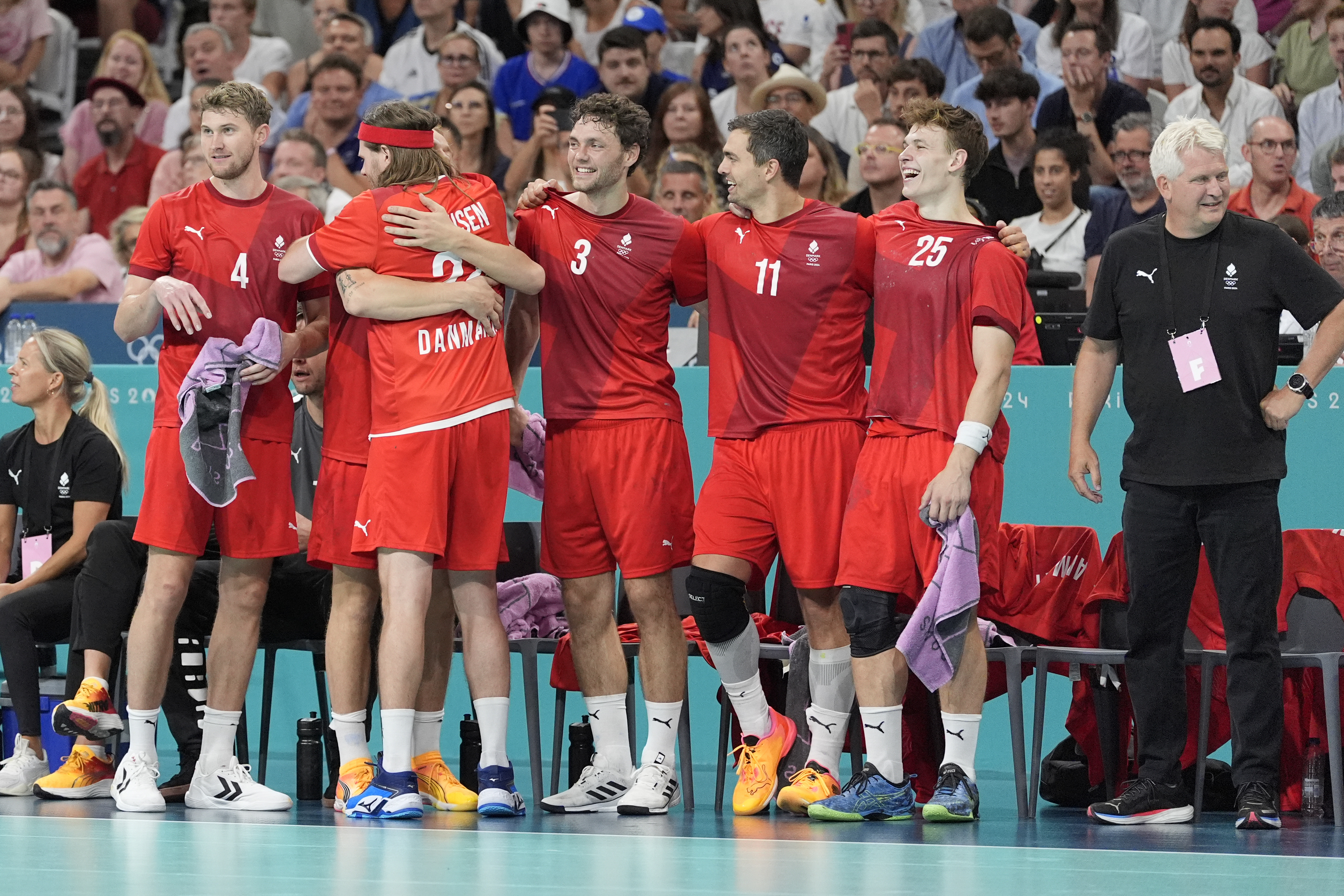 Denmark players celebrate after a goal during the gold medal handball match between Germany and Denmark at the 2024 Summer Olympics, Sunday, Aug. 11, 2024, in Villeneuve-d'Ascq, France.