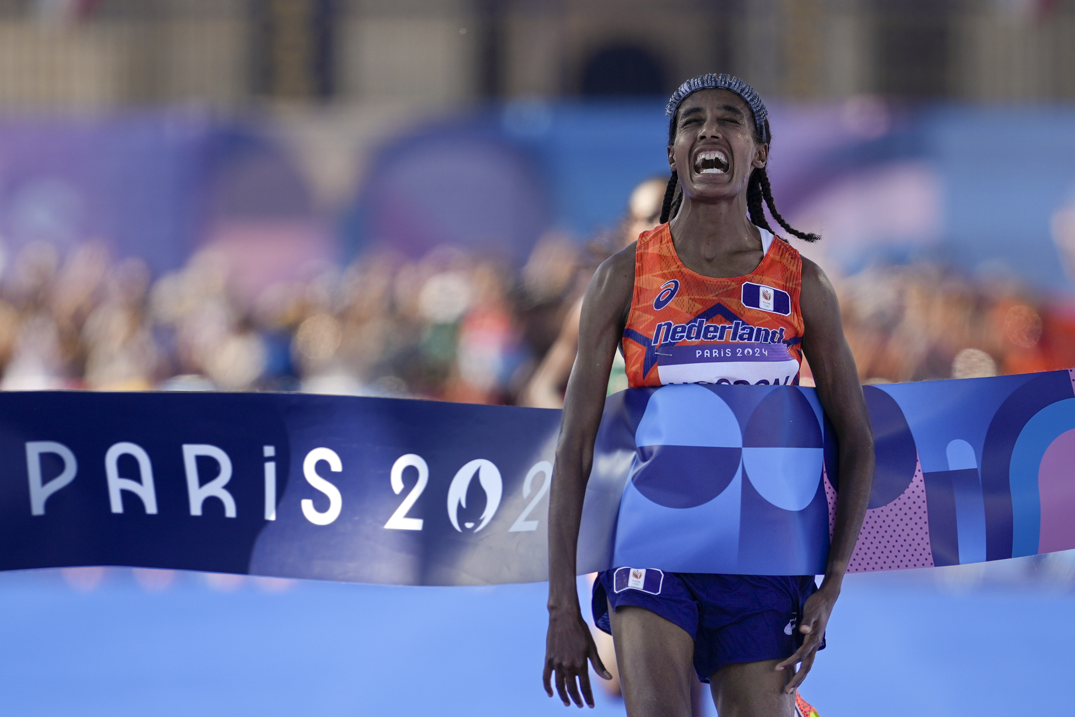 Sifan Hassan, of the Netherlands, celebrates after crossing the finish line to win the gold medal at the end of the women's marathon competition at the 2024 Summer Olympics, Sunday, Aug. 11, 2024, in Paris, France. 