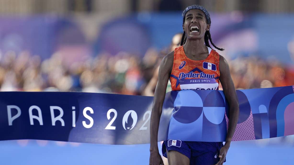 Sifan Hassan, of the Netherlands, celebrates after crossing the finish line to win the gold medal at the end of the women's marathon competition at the 2024 Summer Olympics, Sunday, Aug. 11, 2024, in Paris, France.