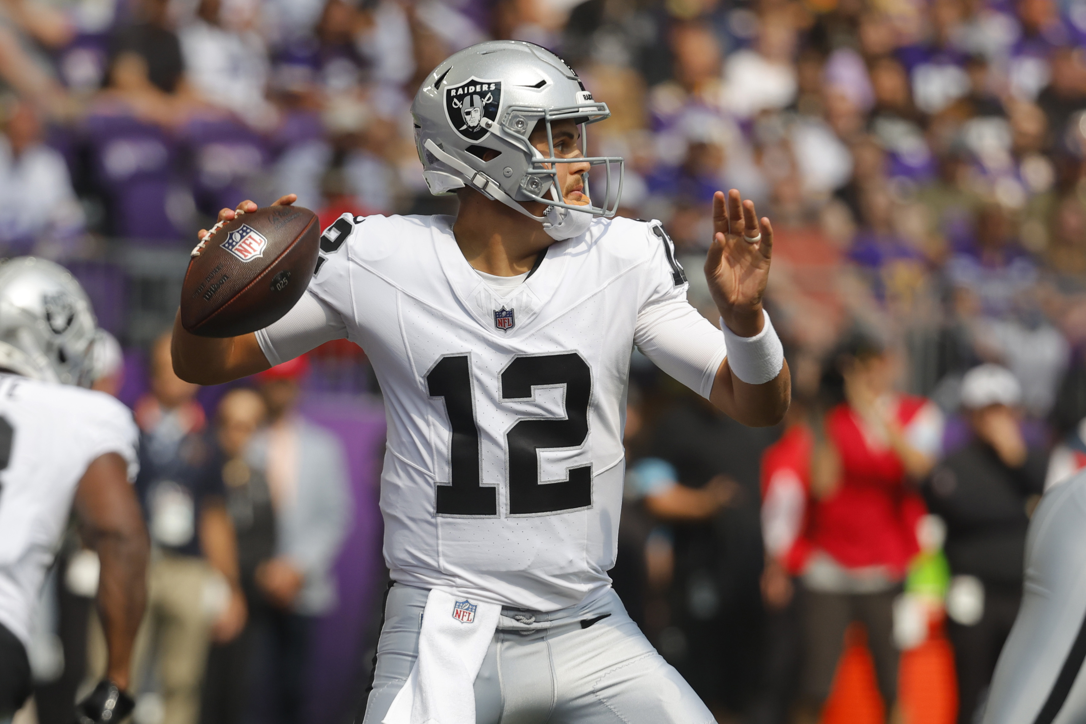 Las Vegas Raiders quarterback Aidan O'Connell (12) throws against the Minnesota Vikings during the first half of an NFL football game Saturday, Aug. 10, 2024, in Minneapolis. 