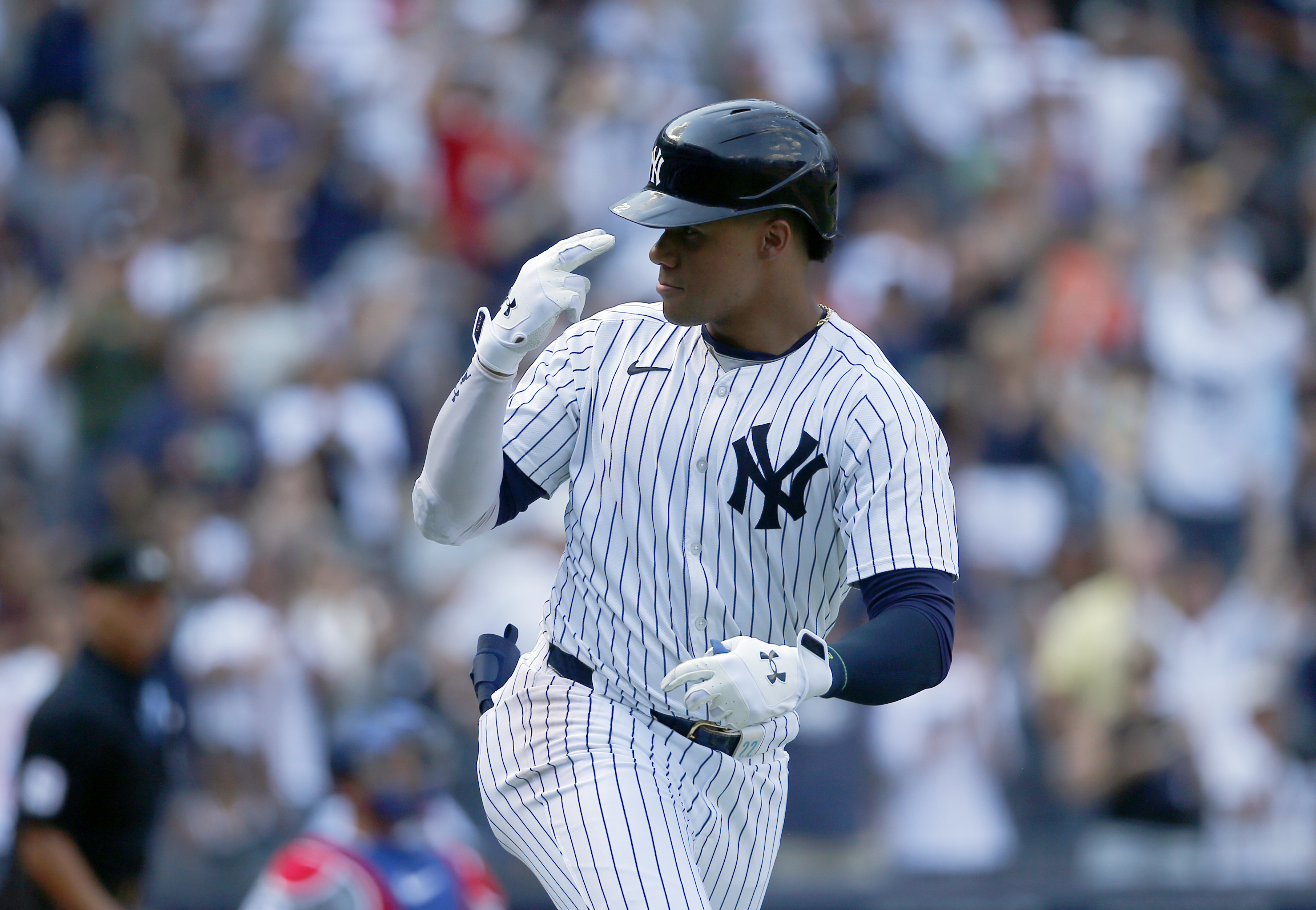 New York Yankees' Juan Soto gestures to his dugout after hitting a home run in the seventh inning, his second of the game, during a baseball game against the Texas Rangers, Sunday, Aug. 11, 2024, in New York.