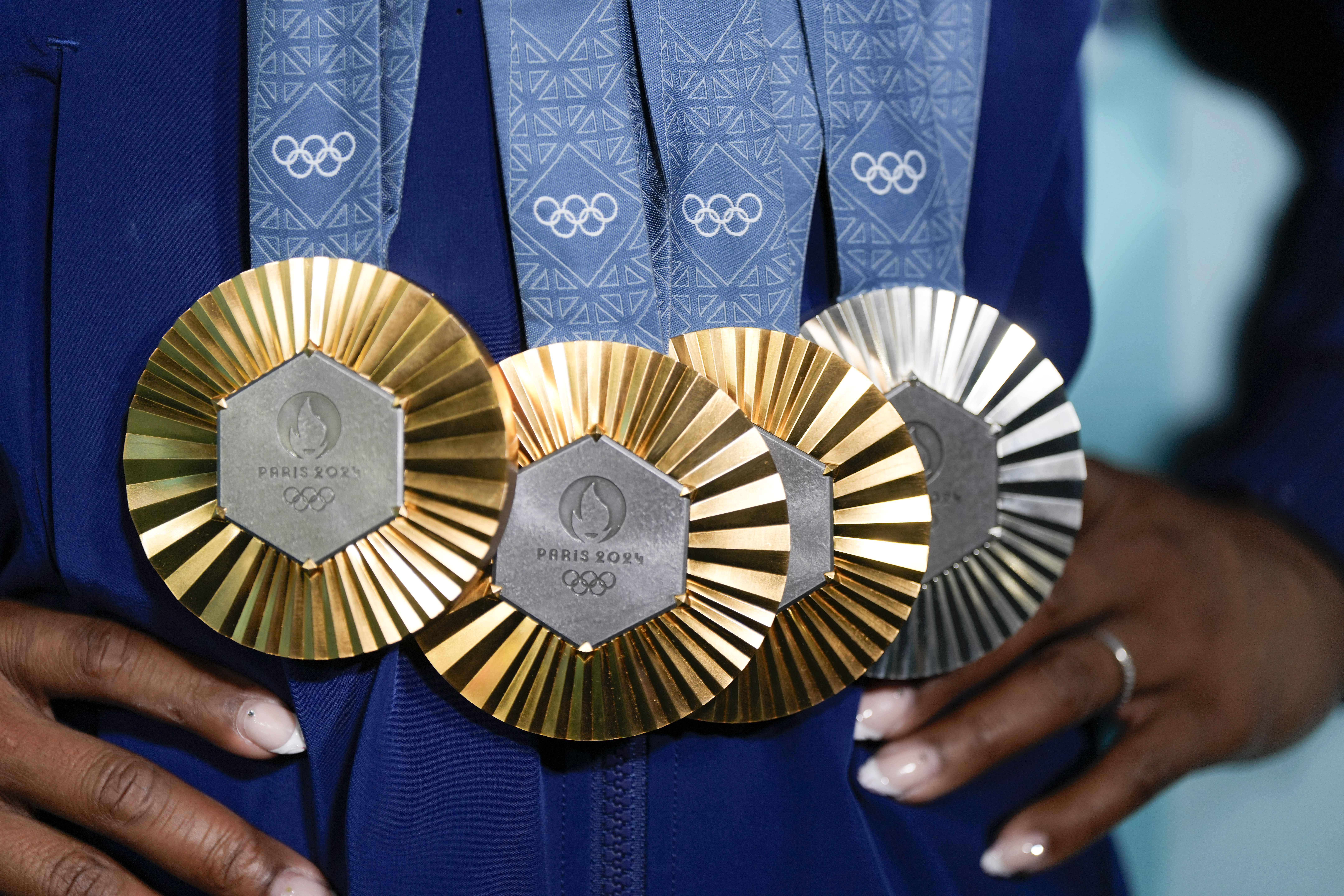 FILE - Simone Biles, of the United States, holds up her medals after the women's artistic gymnastics individual apparatus finals Bercy Arena at the 2024 Summer Olympics, Monday, Aug. 5, 2024, in Paris, France.