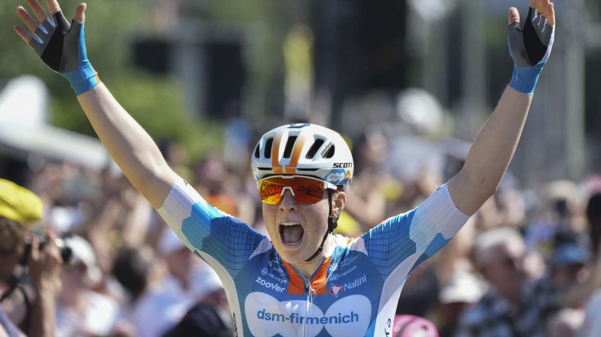 Charlotte Kool of The Netherlands celebrates as she crosses the finish line of the first stage of the Tour de France Women cycling race with start in Rotterdam and finish in The Hague, Netherlands, Monday, Aug. 12, 2024.