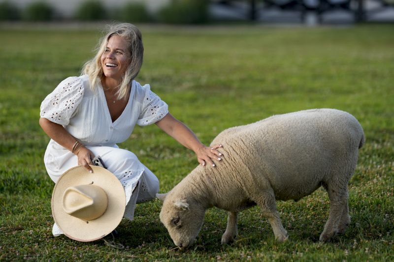 Jamie Campion pets her one of her Southdown Babydoll sheep as it grazes in the backyard on the morning of July 3 in Thompson Station, Tenn.
