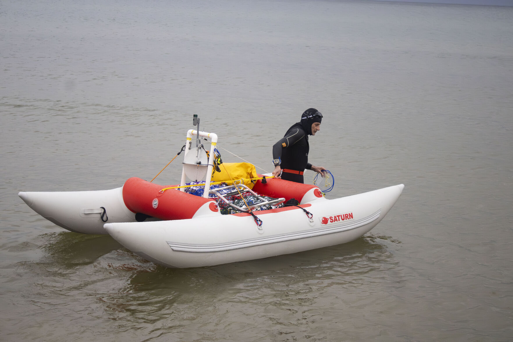 Jim Dreyer heads out into Lake Michigan in Grant Haven, Mich., Aug. 6, 2024, in his attempt to swim to Wisconsin. 