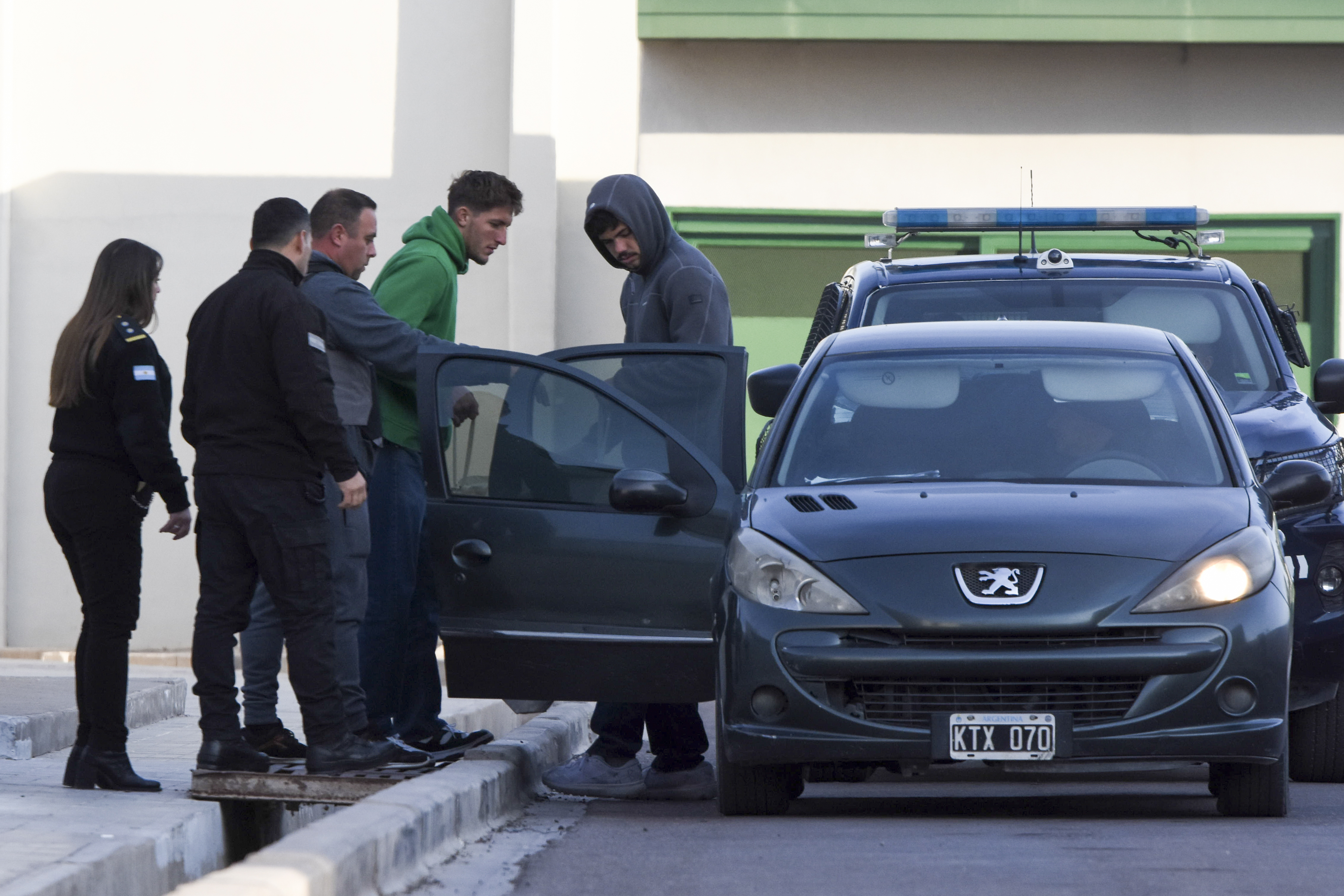 FILE - Police escort French rugby players Oscar Jegou, second from right, and Hugo Auradou, right, from jail after they were given house arrest in Mendoza, Argentina, July 17, 2024. The players were arrested following charges of sexual assault after France played Argentina in Mendoza on July 6.