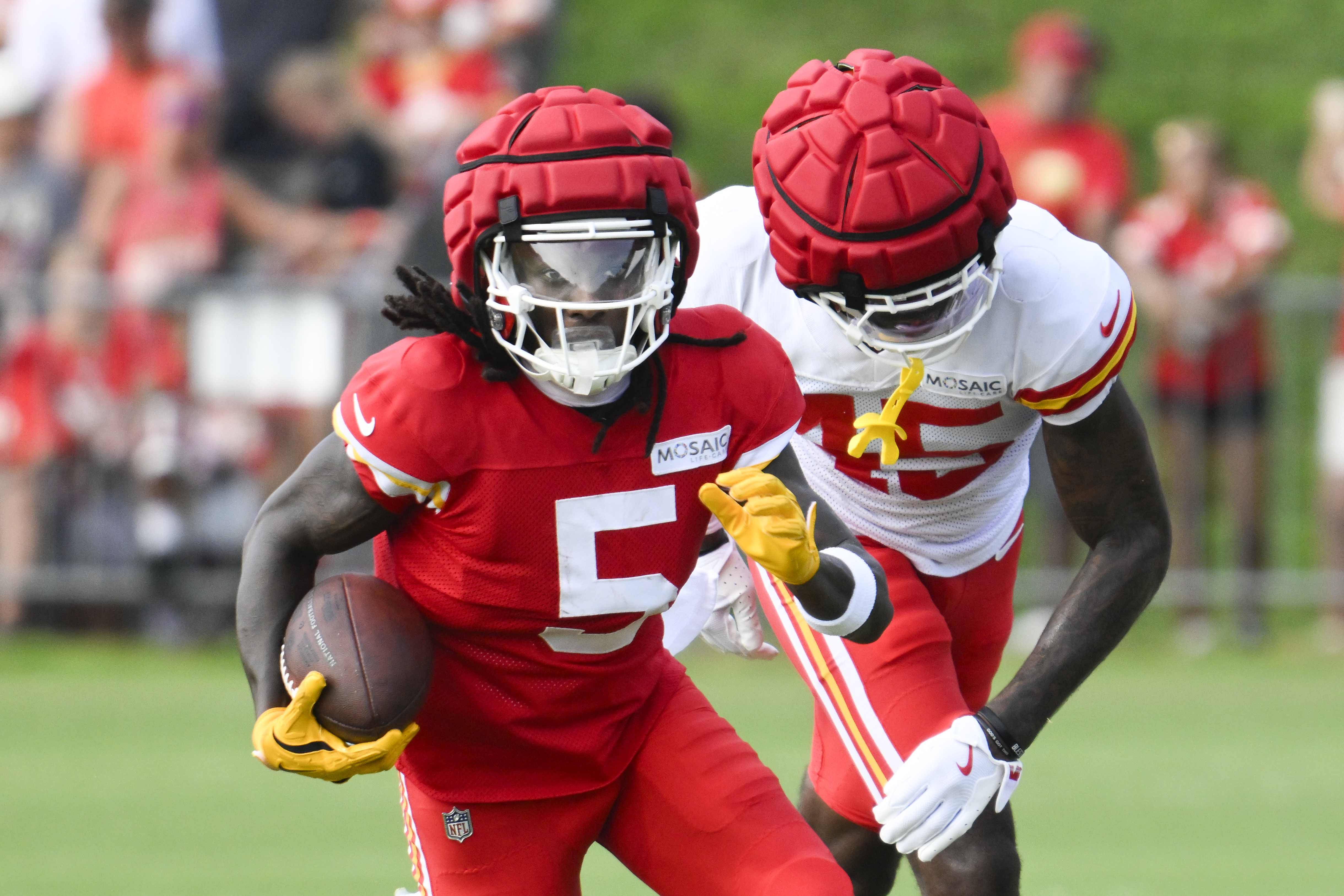 Kansas City Chiefs wide receiver Marquise "Hollywood" Brown (5) runs after a catch as cornerback Miles Battle (45) defends during NFL football training camp Saturday, July 27, 2024, in St. Joseph, Mo.