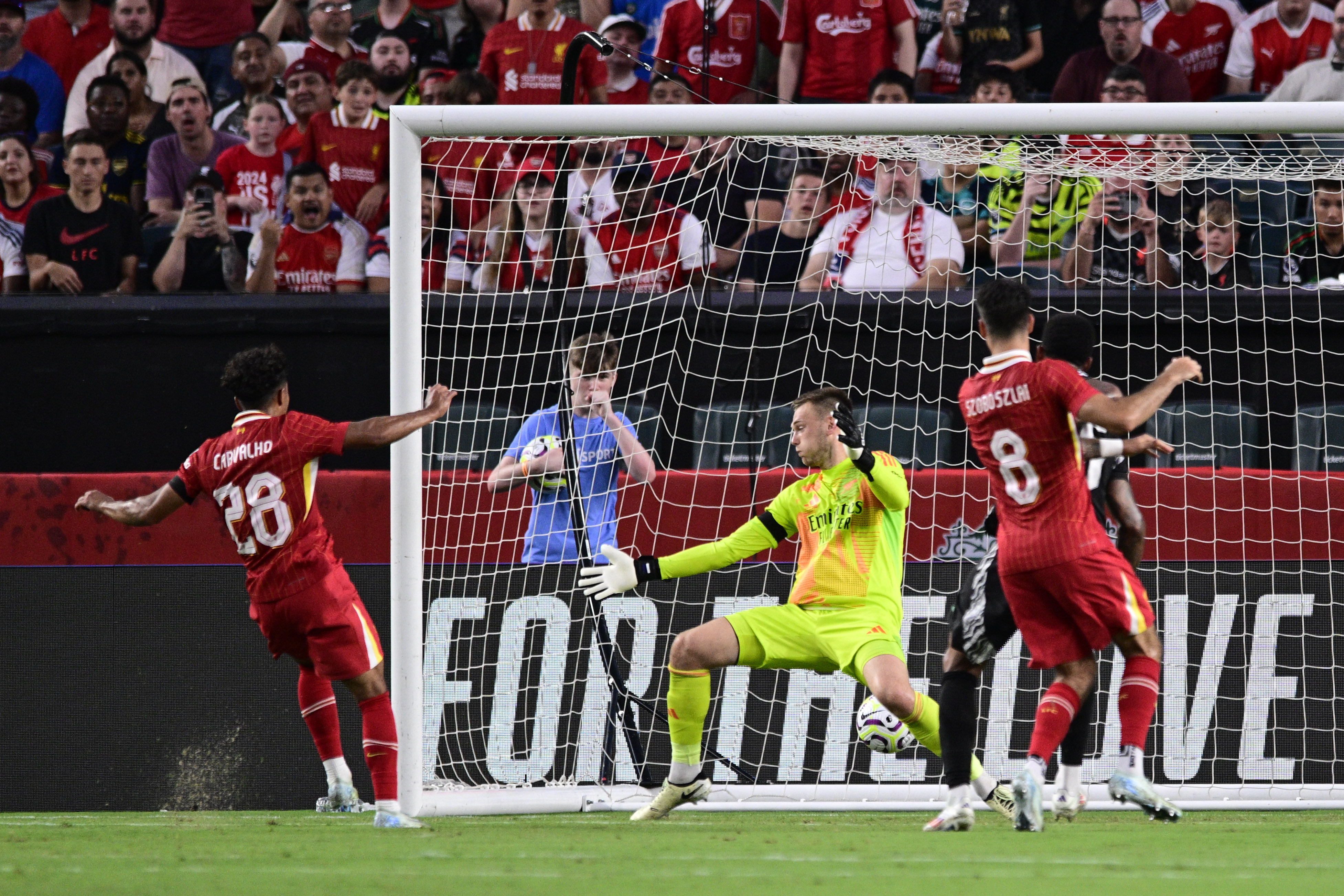 Liverpool's Fabio Carvalho (28) scores a goal past Arsenal goalkeeper Karl Hein, center, during the first half of an international friendly soccer match, Wednesday, July 31, 2024, in Philadelphia.