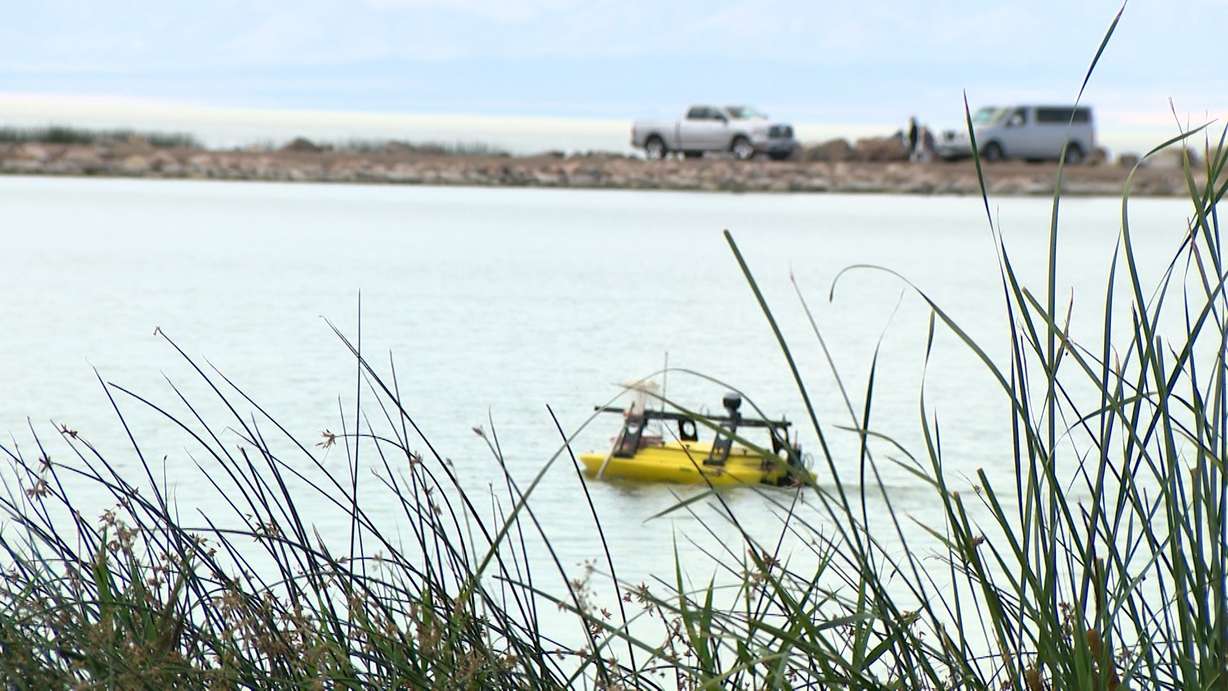 The yellow drone boat floats across the Utah Lake.