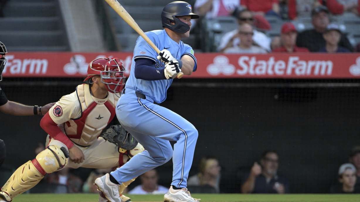 Toronto Blue Jays' Will Wagner, right, hits an RBI single during the third inning of a baseball game against the Los Angeles Angels, Monday, Aug. 12, 2024, in Anaheim, Calif.