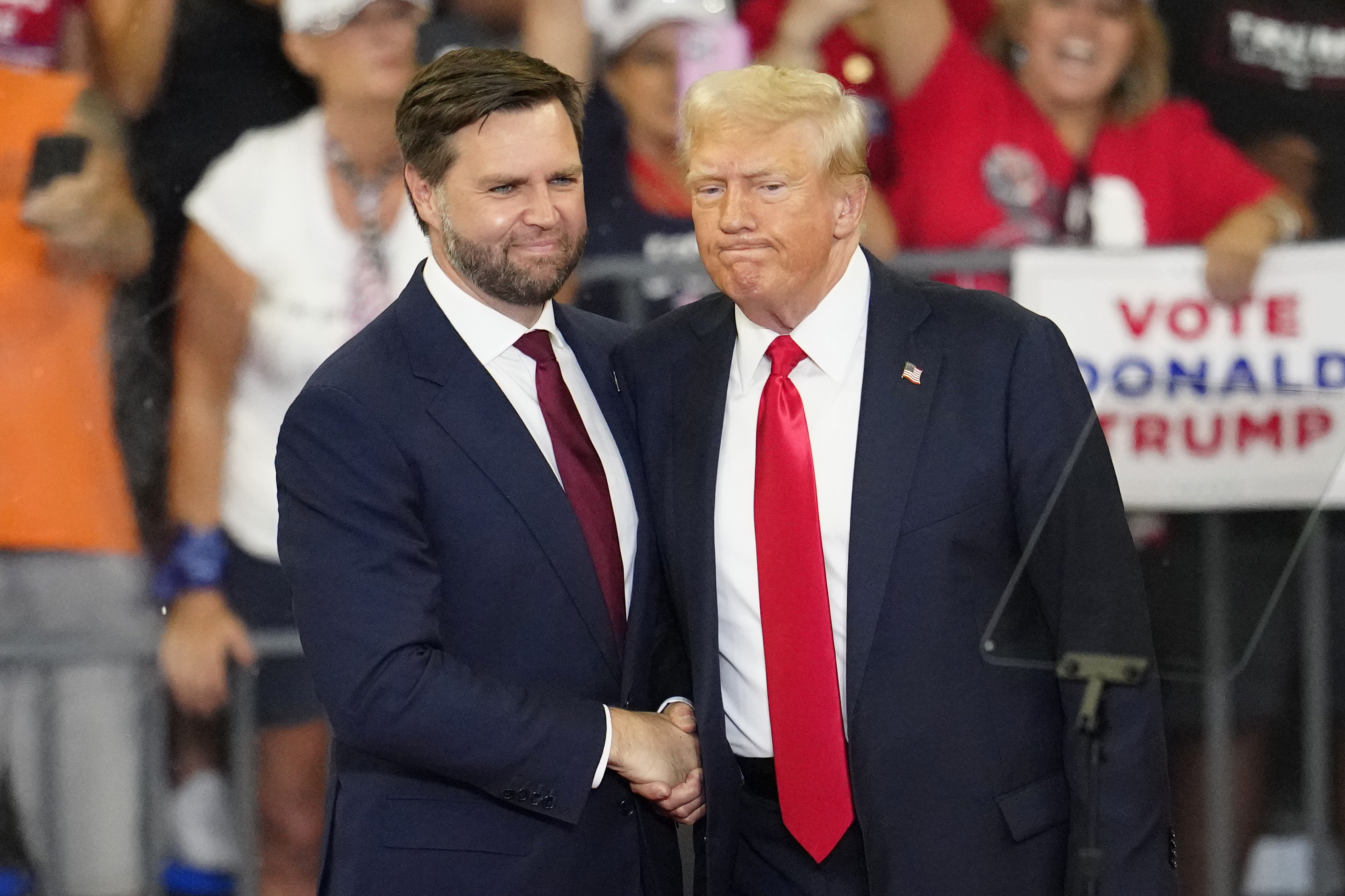 Republican vice presidential candidate Sen. JD Vance, R-Ohio, left, and Republican presidential candidate former President Donald Trump, shake hands at a campaign rally in Atlanta, Aug. 3. Three news outlets were recently leaked confidential material from inside the Trump campaign.