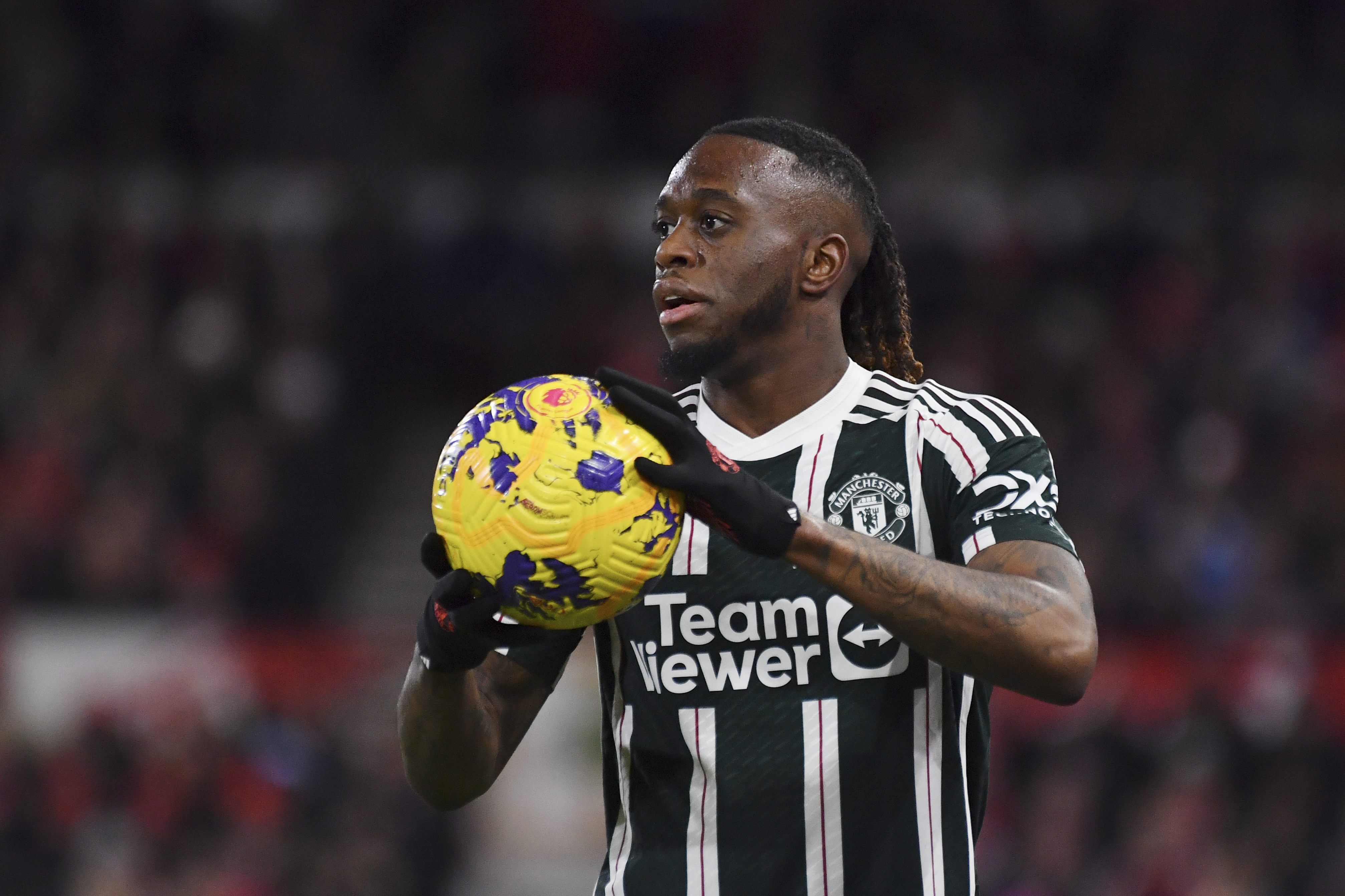 FILE -Manchester United's Aaron Wan-Bissaka holds the ball during the English Premier League soccer match between Nottingham Forest and Manchester United at City Ground in Nottingham, England, Saturday, Dec. 30, 2023.