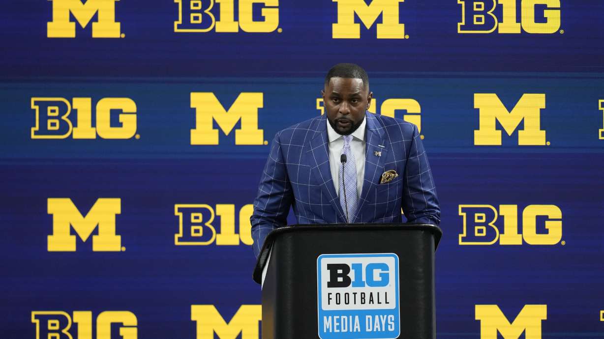 FILE - Michigan head coach Sherrone Moore speaks during an NCAA college football news conference at the Big Ten Conference media days at Lucas Oil Stadium, July 25, 2024, in Indianapolis.