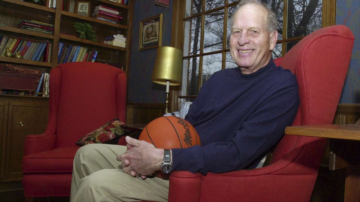 FILE - Frank Selvy poses with a basketball that belongs to his son, Mike, at his home Thursday, Feb. 5, 2004, in Simpsonville, S.C. Selvy, an All-America guard at Furman who scored an NCAA Division I-record 100 points in a game and later played nine NBA seasons, died Tuesday, Aug. 13, 2024.