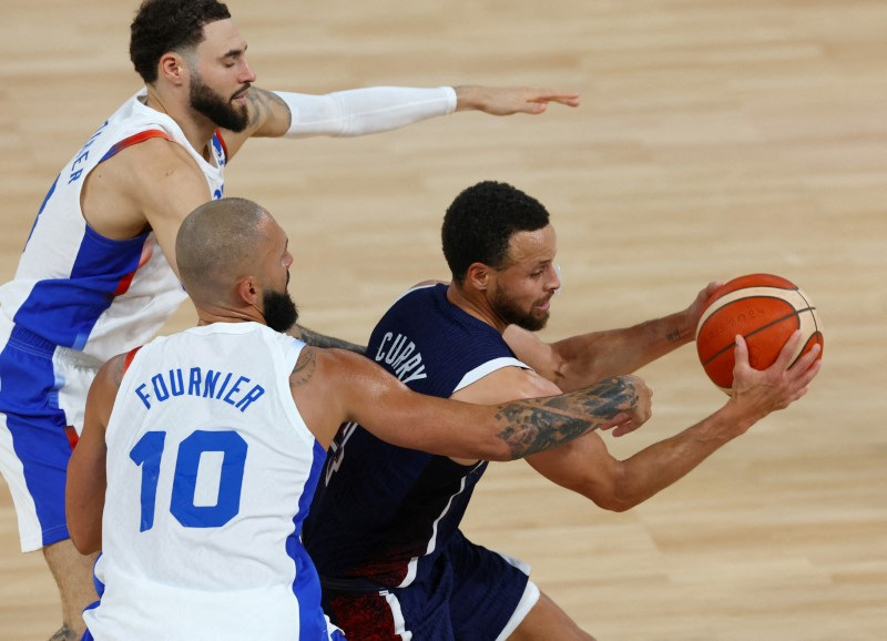 U.S. player Stephen Curry plays against Evan Fournier of France and Isaia Cordinier of France Aug. 10 in Paris, France. McDonald's France humorously posted on social media about ending its curry sauce.