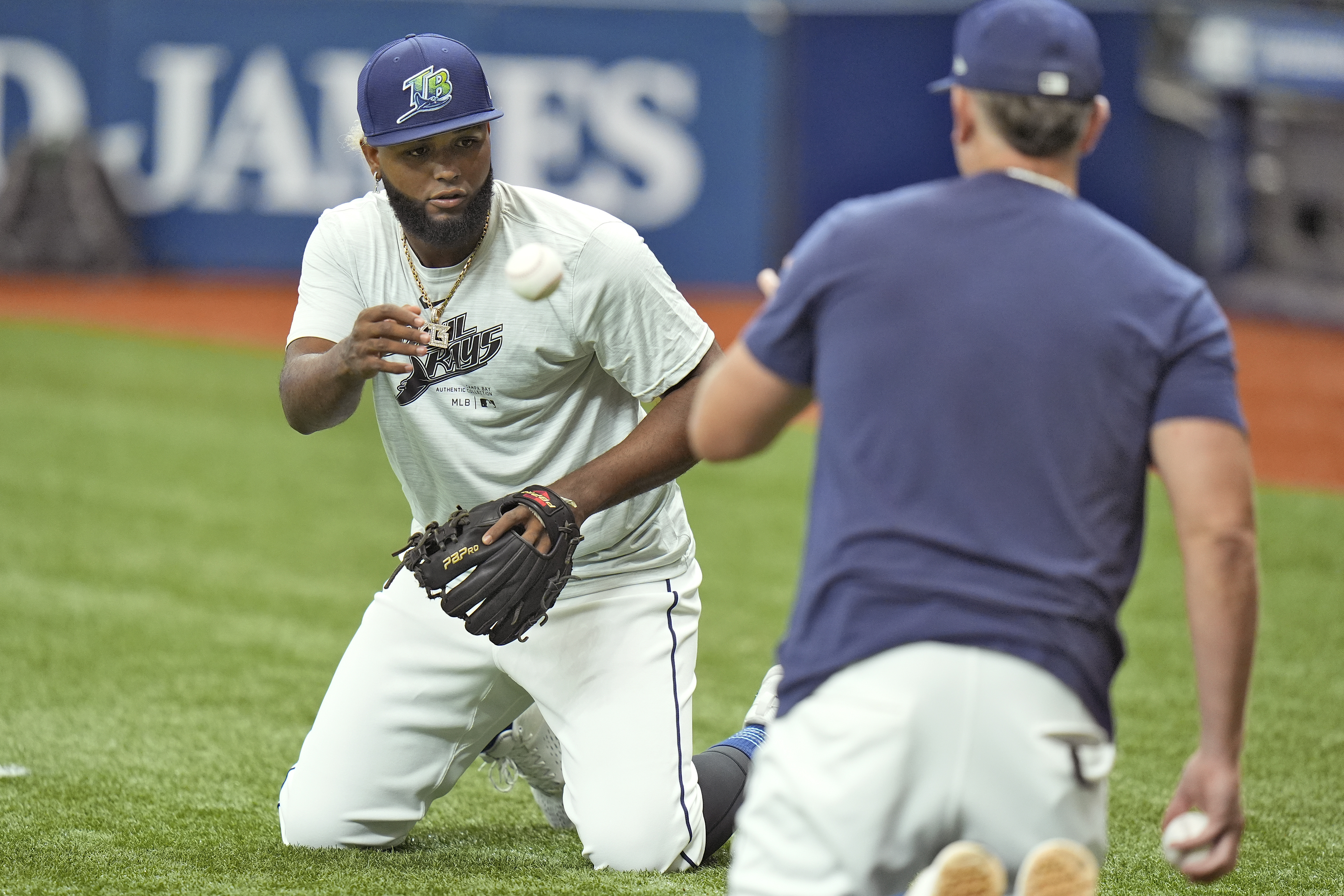 Newly called up Tampa Bay Rays third baseman Junior Caminero, left, works on drills with Brady Williams before a baseball game against the Houston Astros Tuesday, Aug. 13, 2024, in St. Petersburg, Fla. 