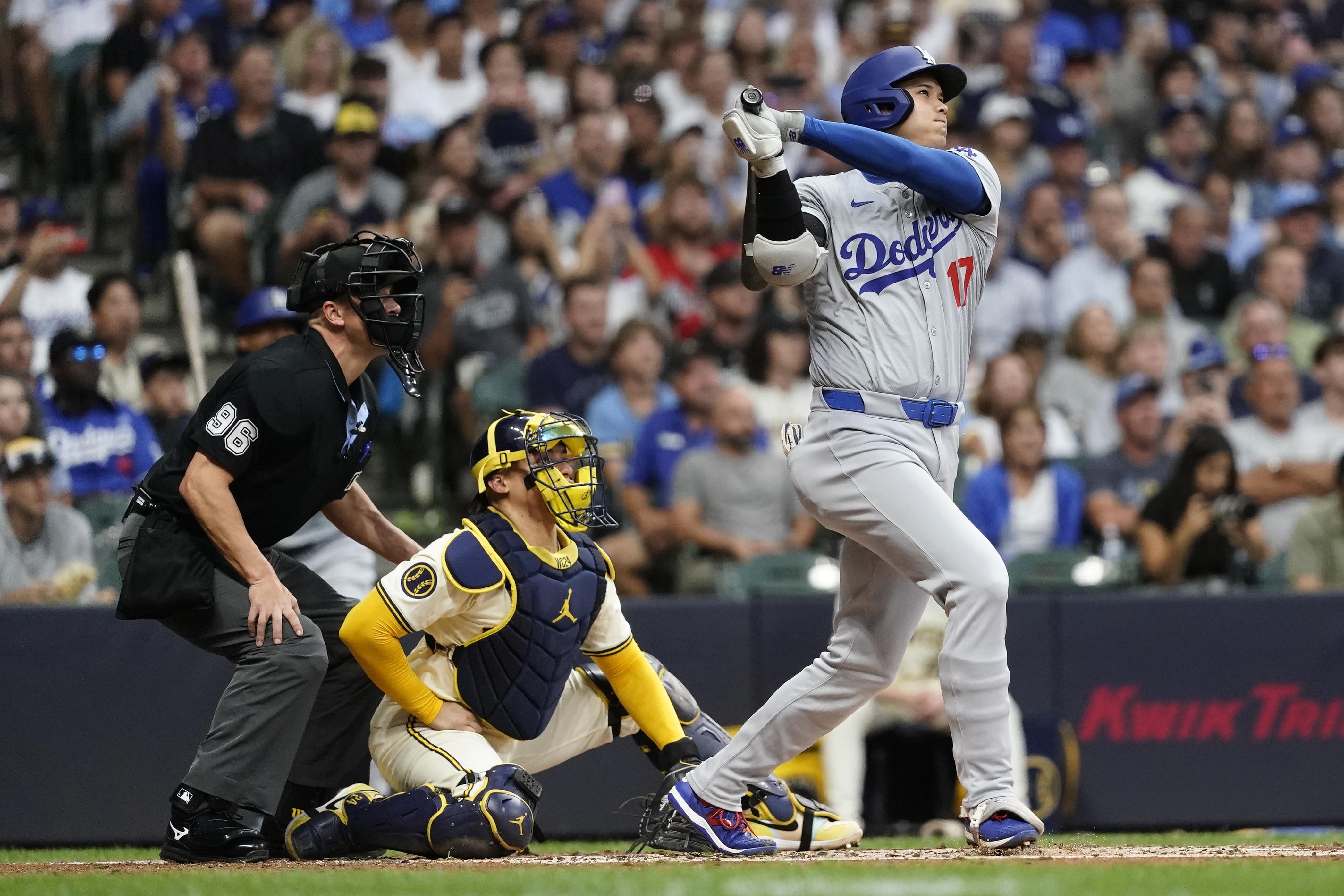 Los Angeles Dodgers' Shohei Ohtani hits a solo home run during the third inning of a baseball game against the Milwaukee Brewers, Tuesday, Aug. 13, 2024, in Milwaukee. 