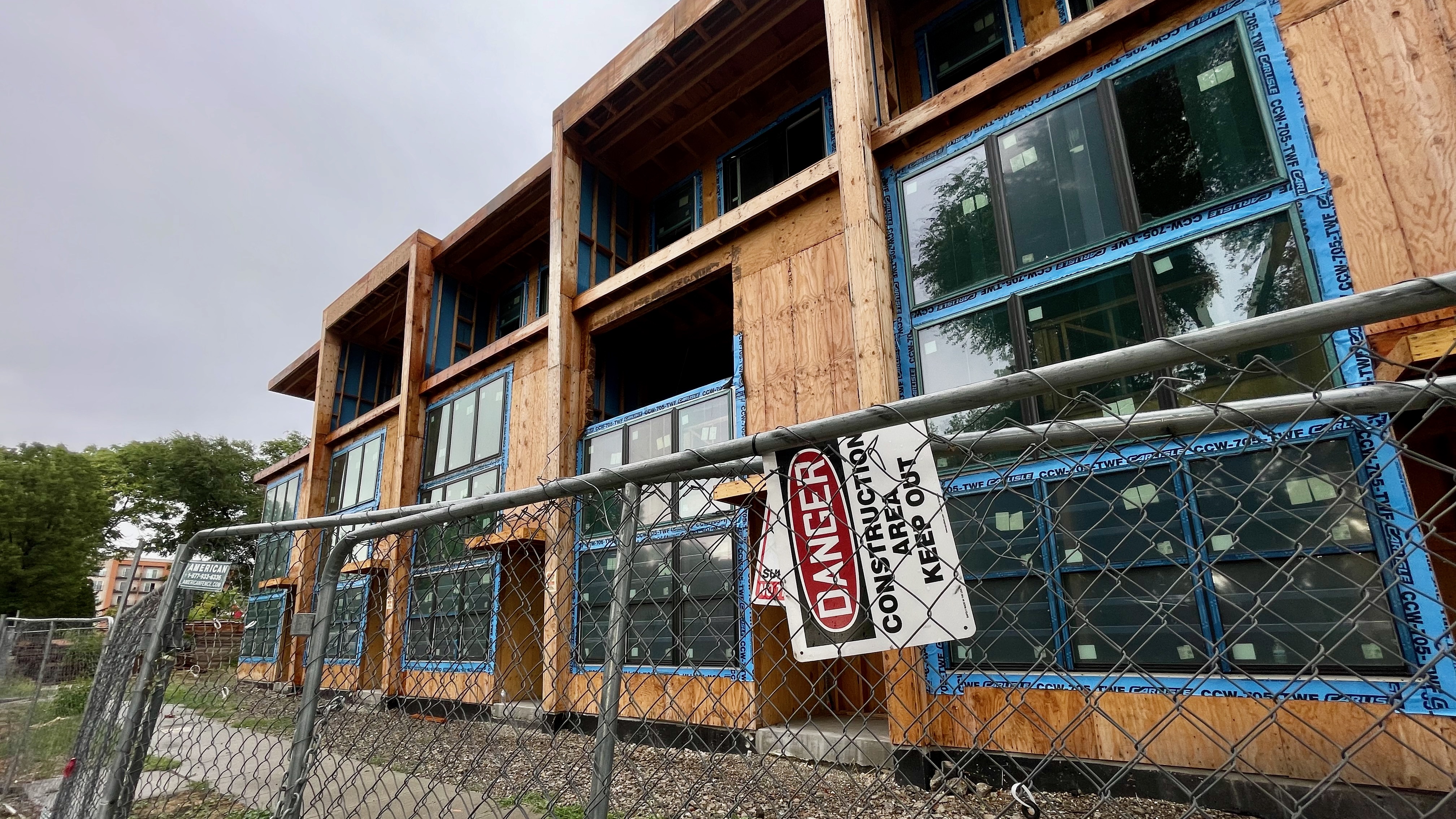 A partially completed townhome complex on Salt Lake City's west side next-door to the home owned by Jose Luis Leal on Monday.