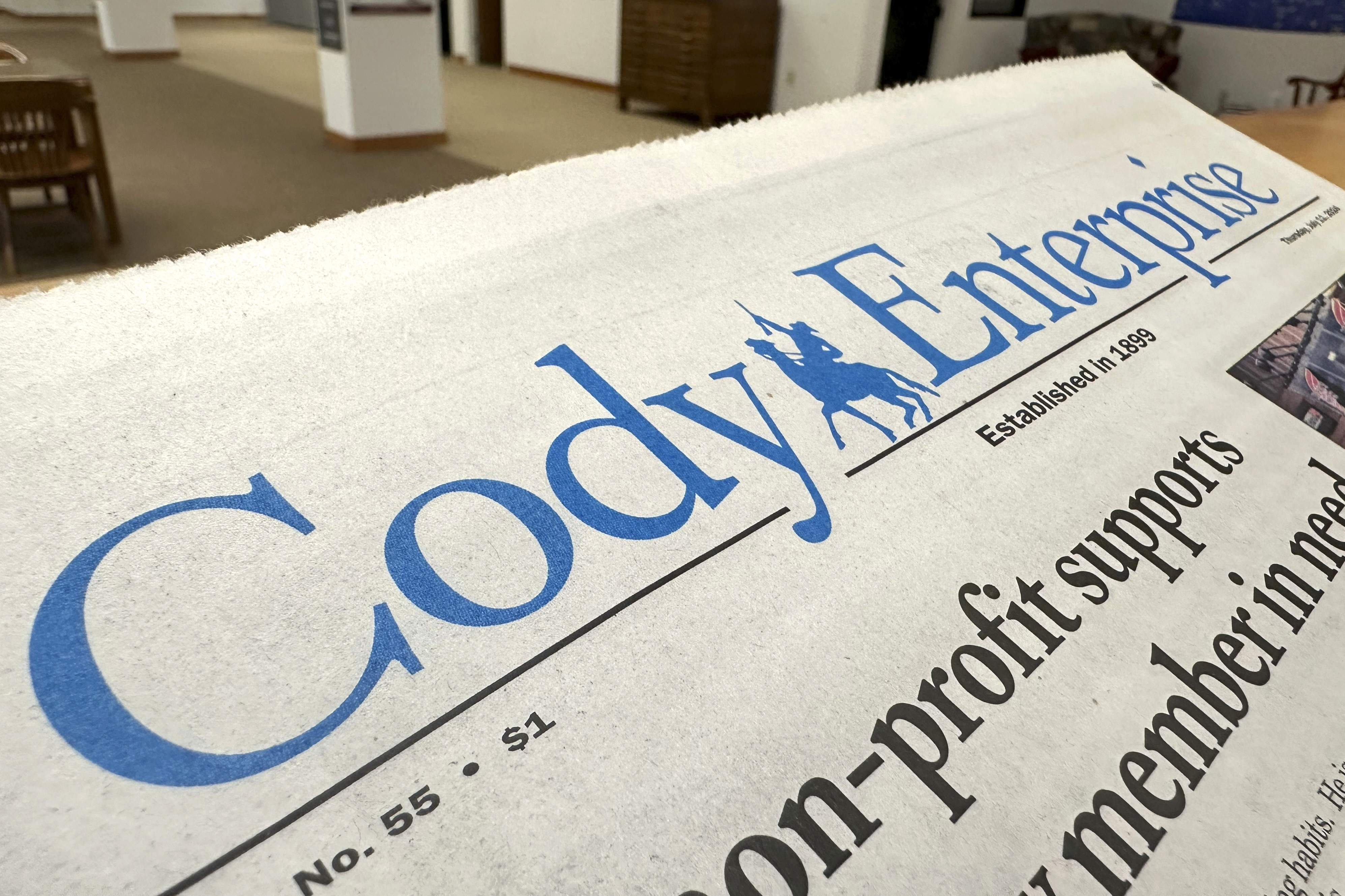 A recent issue of the Cody Enterprise, the Wyoming newspaper where a reporter used artificial intelligence to help write his stories, is seen Tuesday at the Wyoming State Library in Cheyenne. 