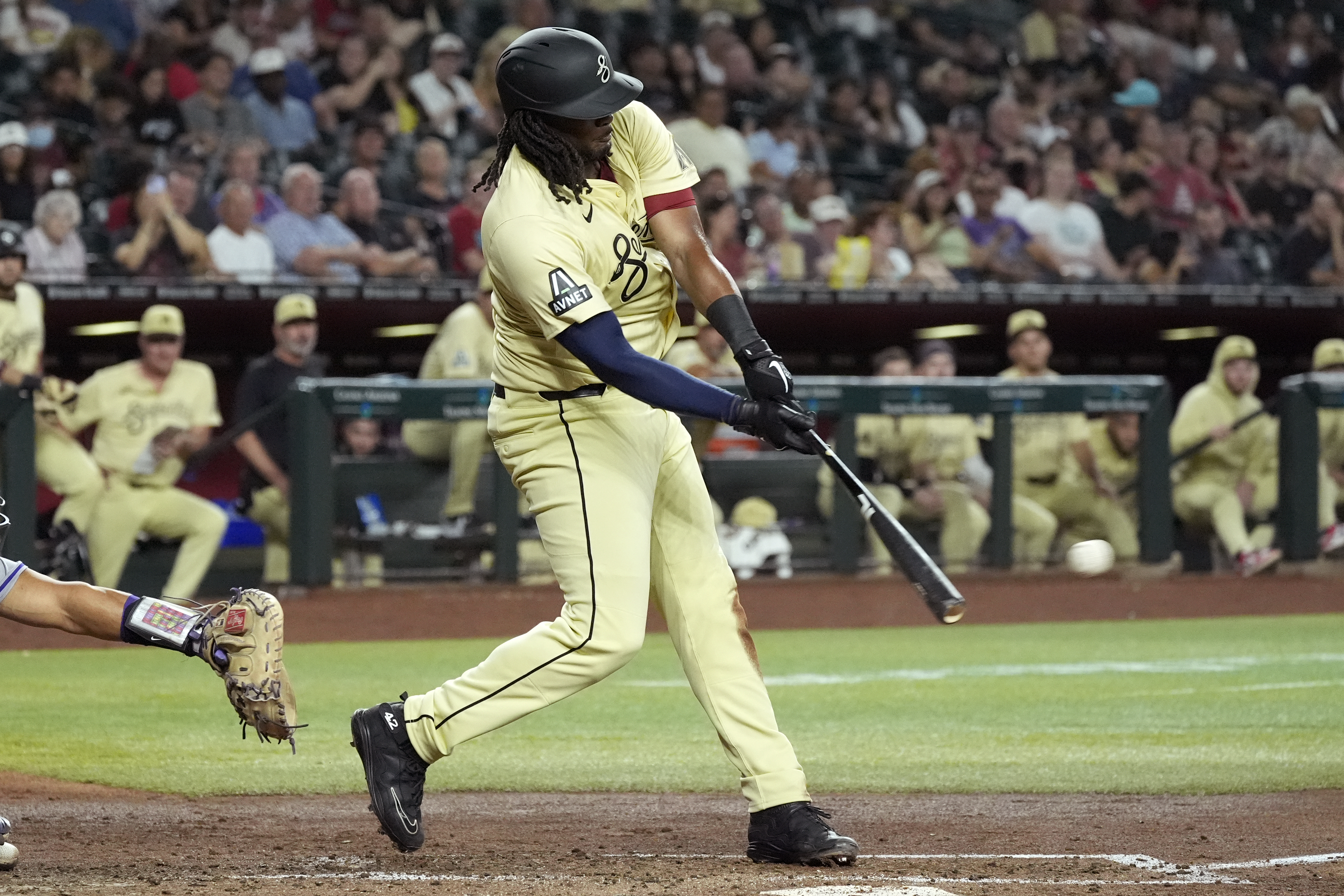 Arizona Diamondbacks' Josh Bell connects for a run-scoring double against the Colorado Rockies during the third inning of a baseball game, Tuesday, Aug. 13, 2024, in Phoenix. 