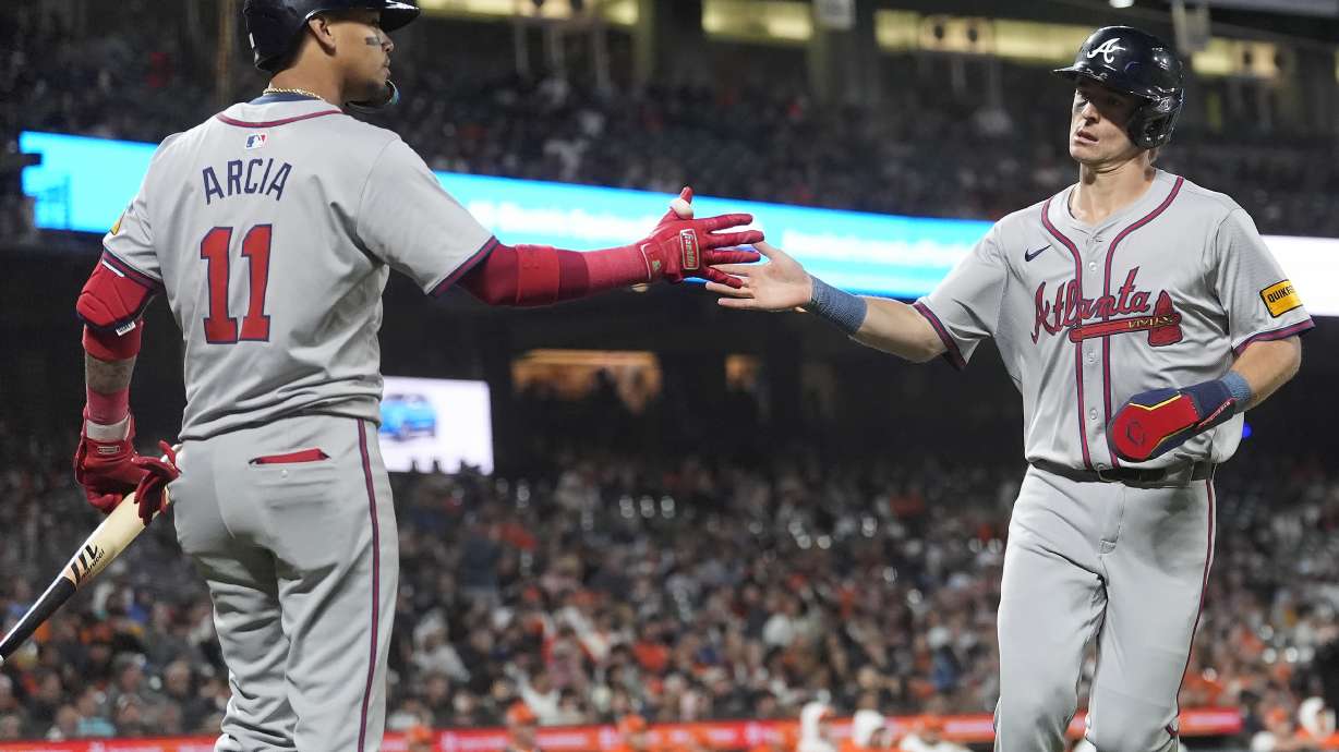 Atlanta Braves' Luke Williams, right, is congratulated by Orlando Arcia after scoring against the San Francisco Giants during the 10th inning of a baseball game in San Francisco, Tuesday, Aug. 13, 2024.