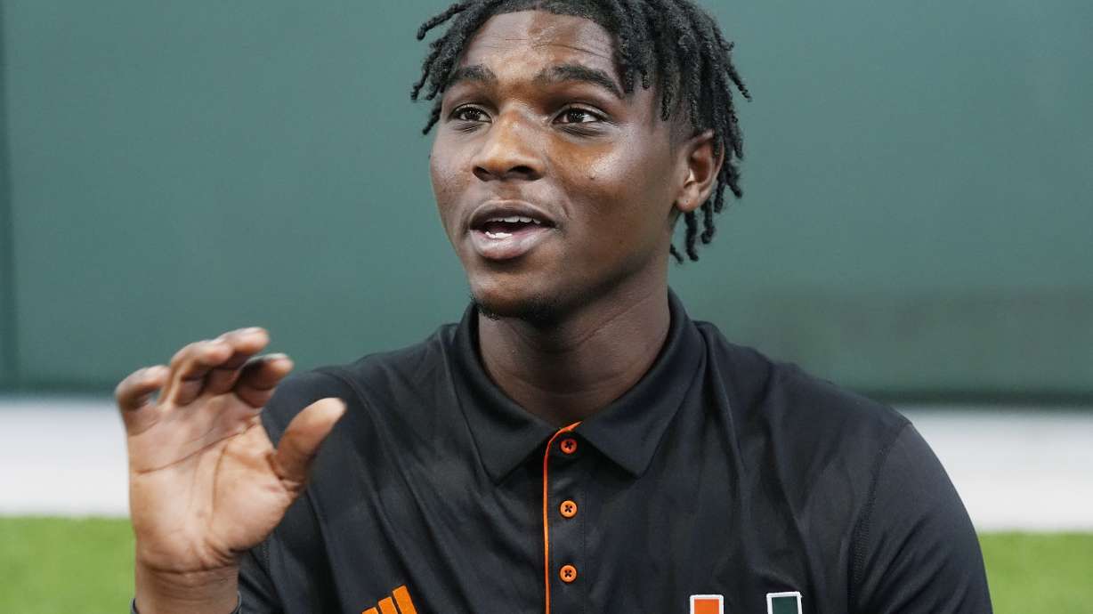 Miami quarterback Cam Ward asnwers questions during NCAA college football media day, Tuesday, July 30, 2024, in Coral Gables, Fla.