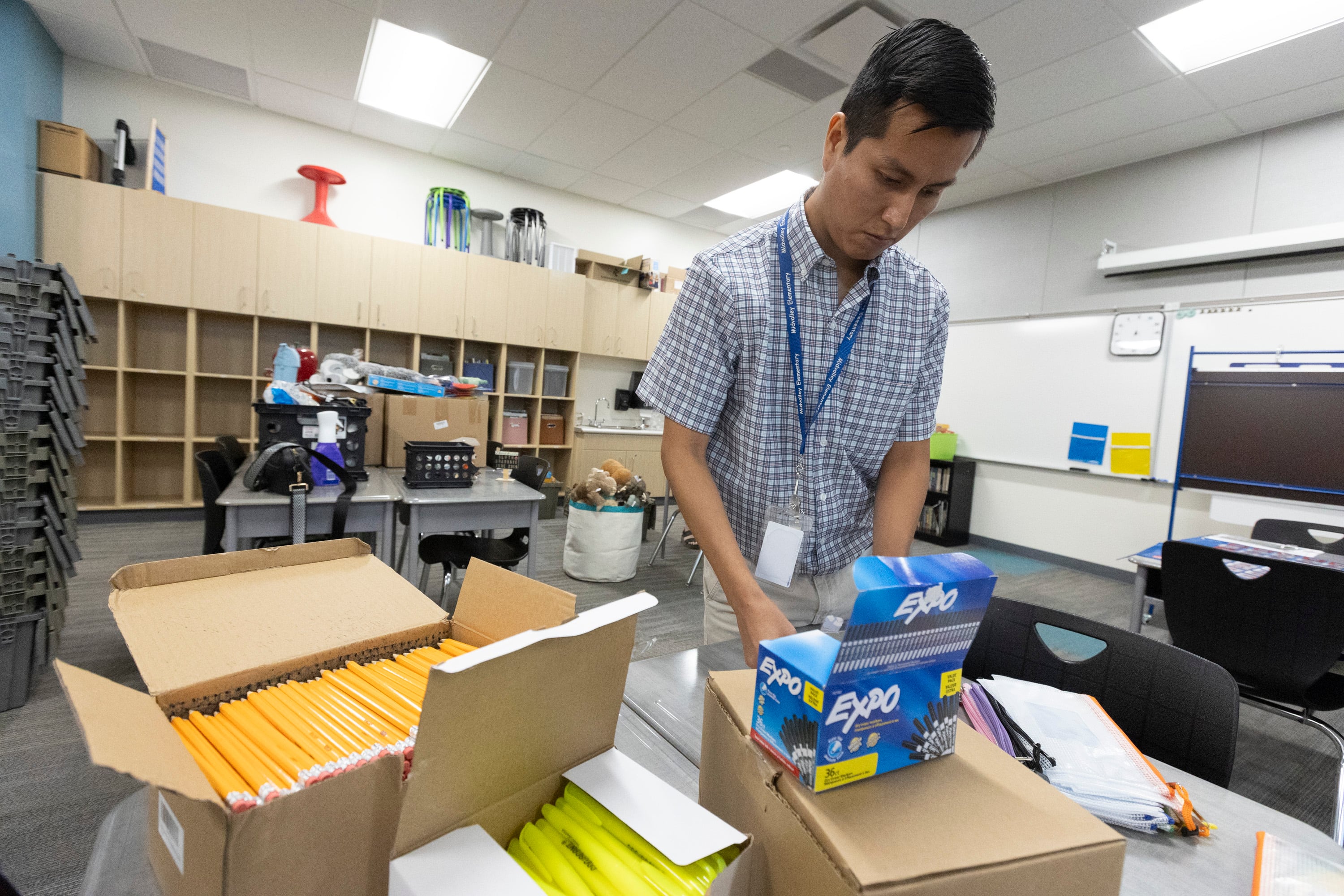 Fourth grade teacher Jose Navarrete prepares his classroom for the first day of school at Midvalley Elementary School in Midvale on Monday.