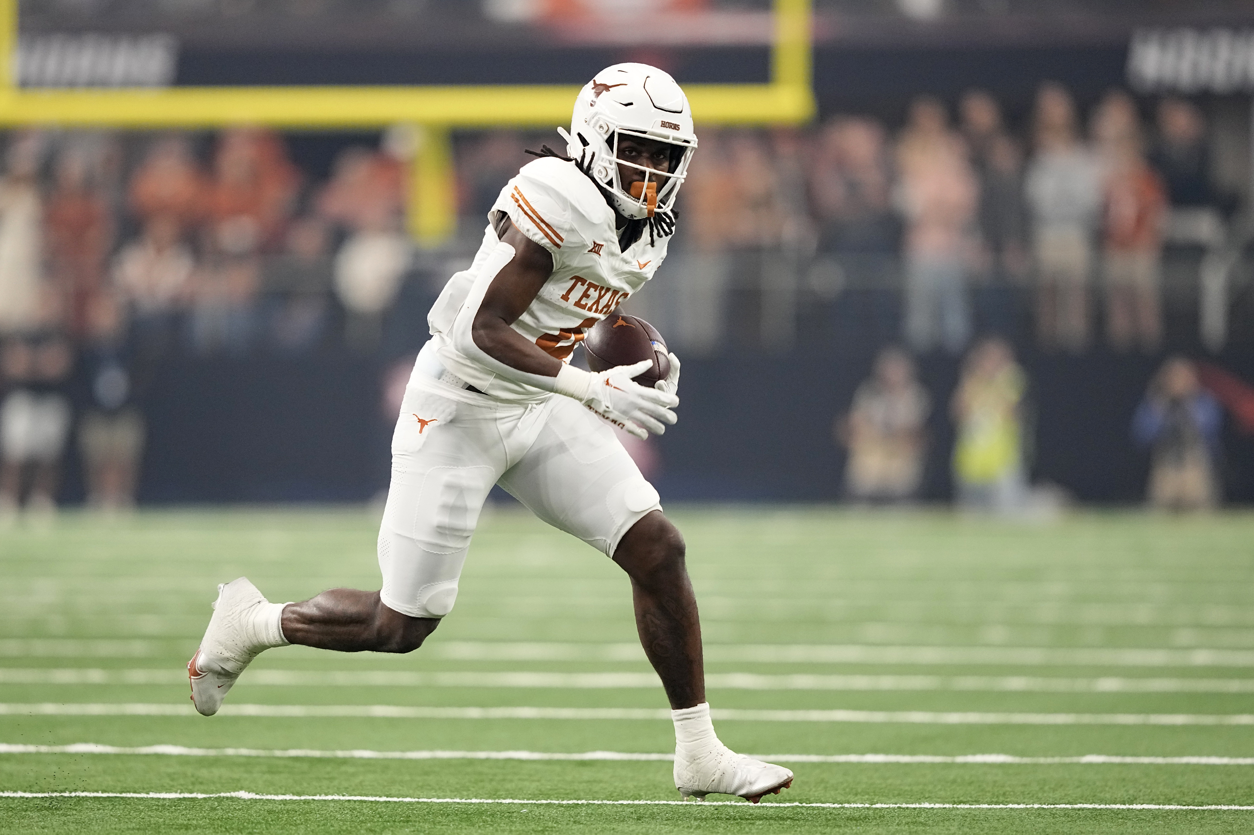 FILE - Texas running back CJ Baxter (4) runs the ball during the Big 12 Conference championship NCAA college football game against Oklahoma State in Arlington, Texas, Saturday, Dec. 2, 2023. 