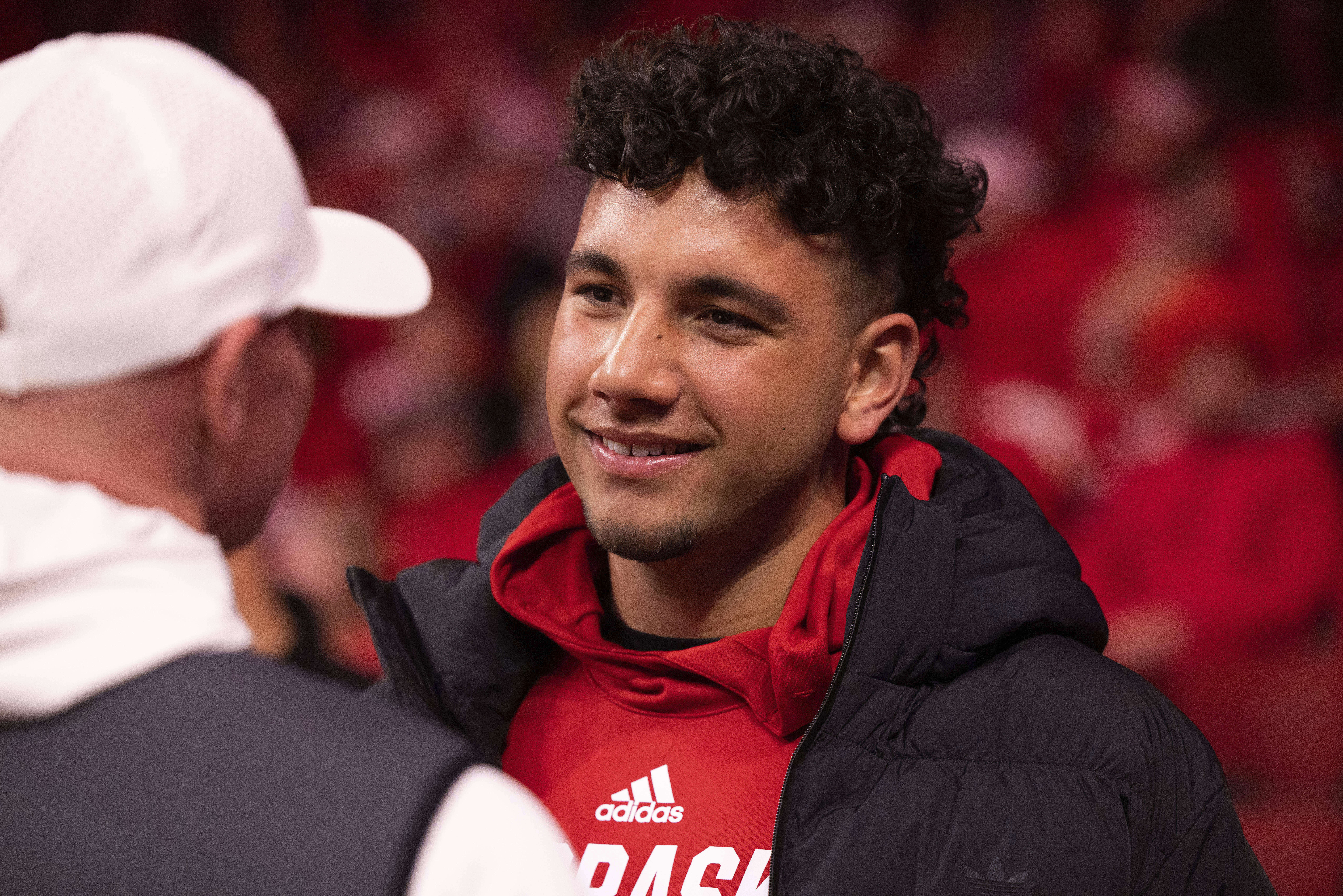 FILE - Dylan Raiola chats with supporters courtside before an NCAA college basketball game between Nebraska and Indiana, Wednesday, Jan. 3, 2024, in Lincoln, Neb. 