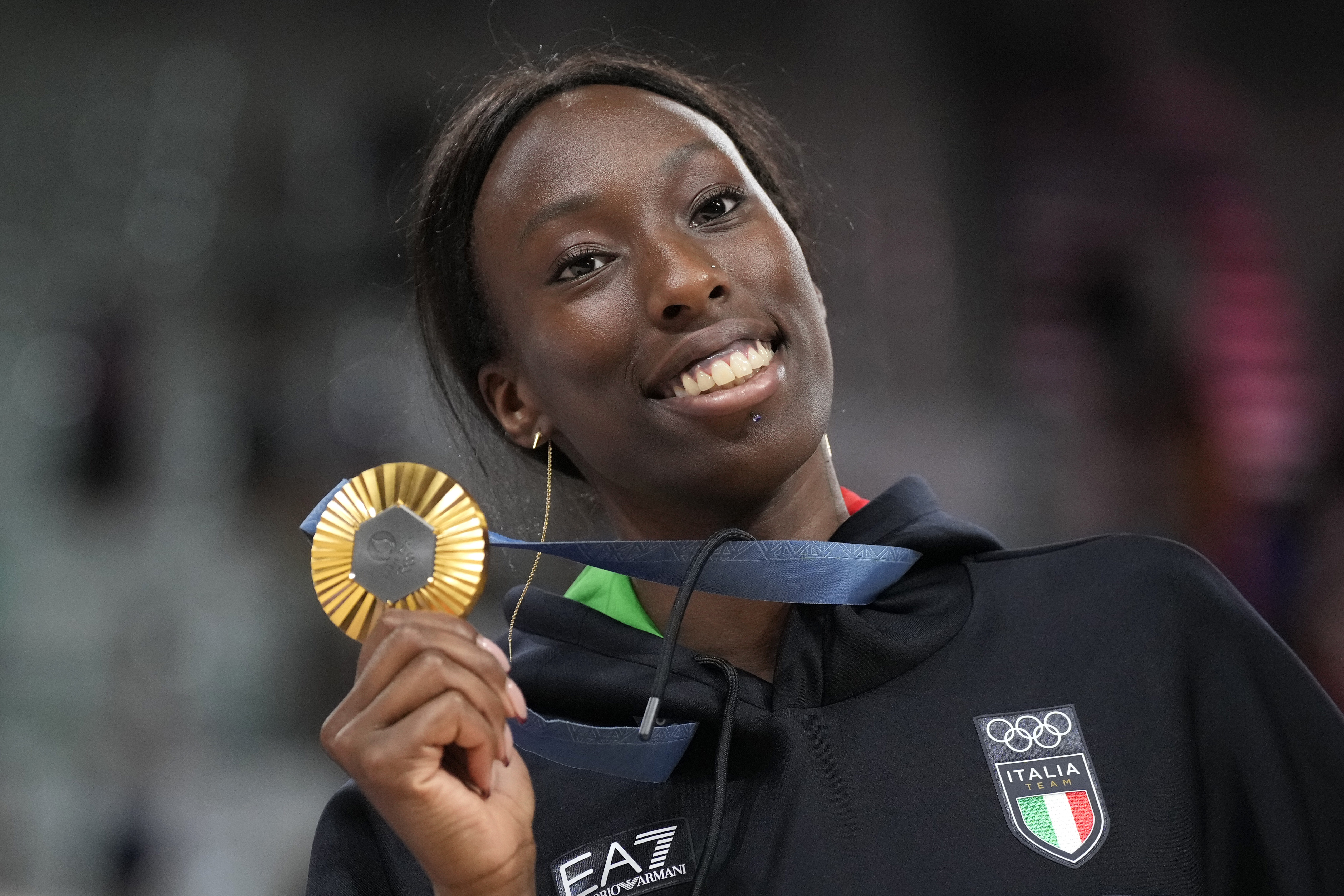 Paola Egonu of Italy shows her gold medal after the medal ceremony at the end of the women's volleyball final match against the United States of America at the 2024 Summer Olympics, Sunday, Aug. 11, 2024, in Paris, France.