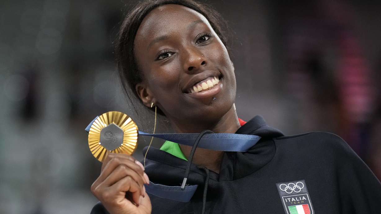 Paola Egonu of Italy shows her gold medal after the medal ceremony at the end of the women's volleyball final match against the United States of America at the 2024 Summer Olympics, Sunday, Aug. 11, 2024, in Paris, France.