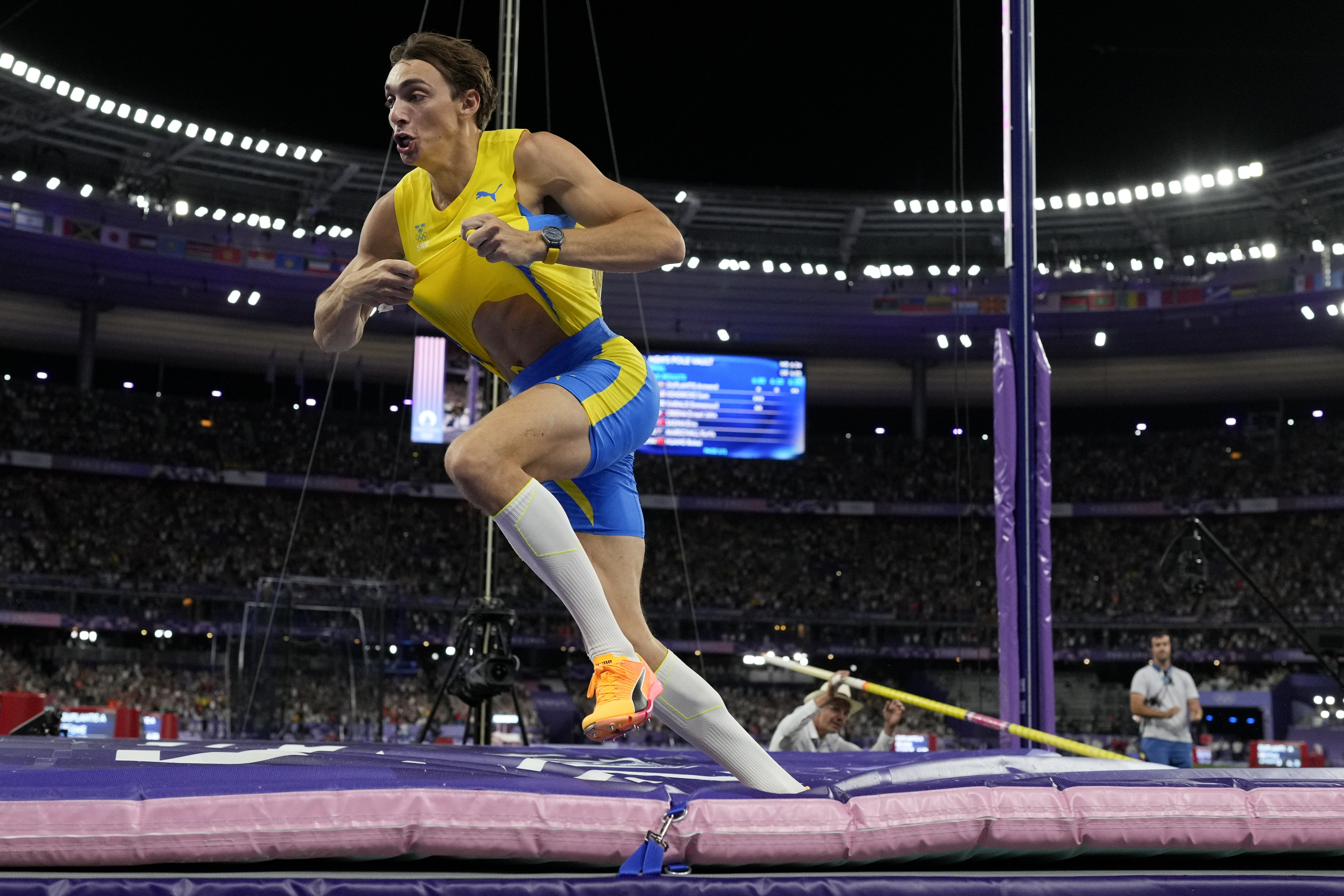Armand Duplantis, of Sweden, celebrates after setting a new world record in the men's pole vault final at the 2024 Summer Olympics, Monday, Aug. 5, 2024, in Saint-Denis, France. 