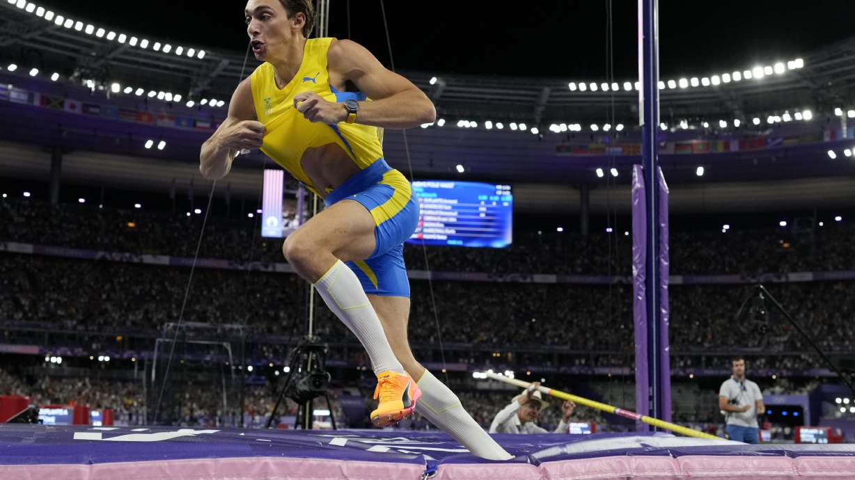 Armand Duplantis, of Sweden, celebrates after setting a new world record in the men's pole vault final at the 2024 Summer Olympics, Monday, Aug. 5, 2024, in Saint-Denis, France.