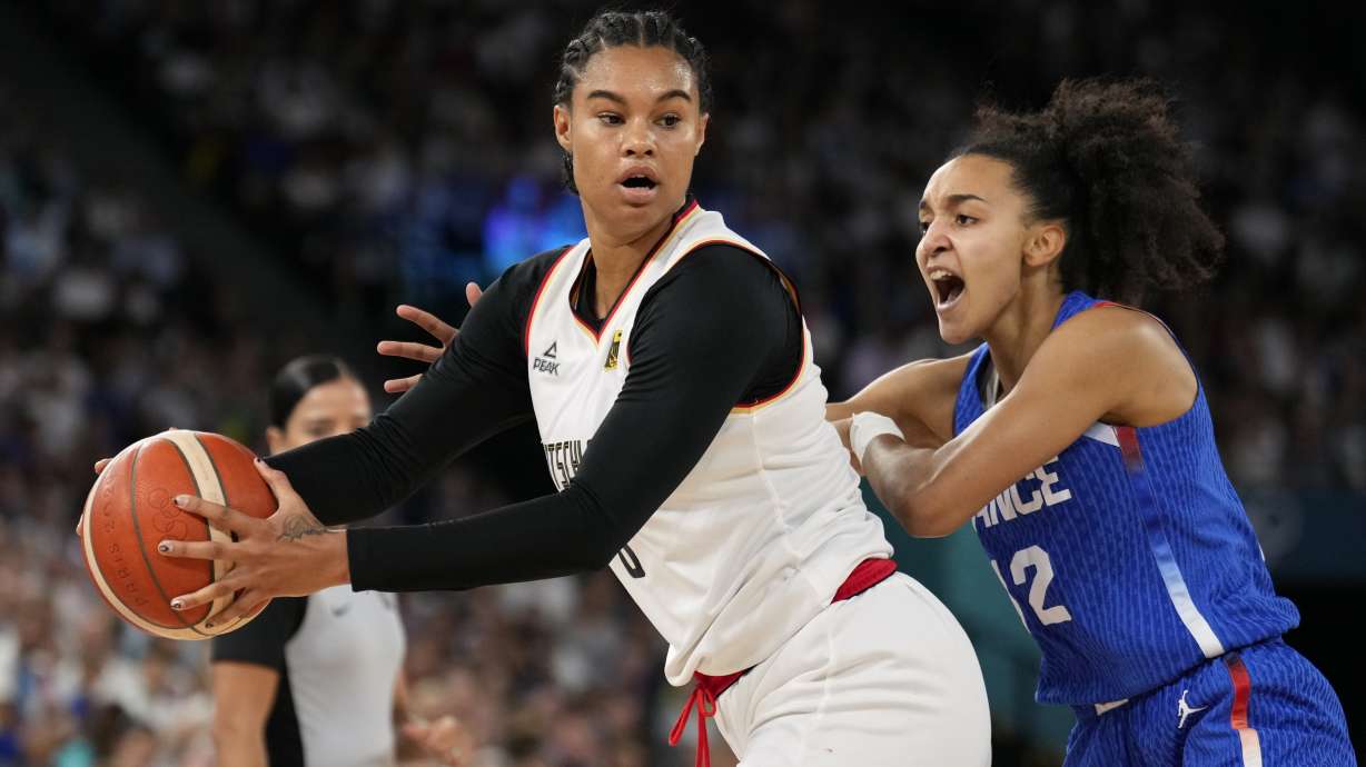 Iliana Rupert (12), of France, defends Satou Sabally (0), of Germany, during a women's quarterfinal game at Bercy Arena at the 2024 Summer Olympics, Wednesday, Aug. 7, 2024, in Paris, France.