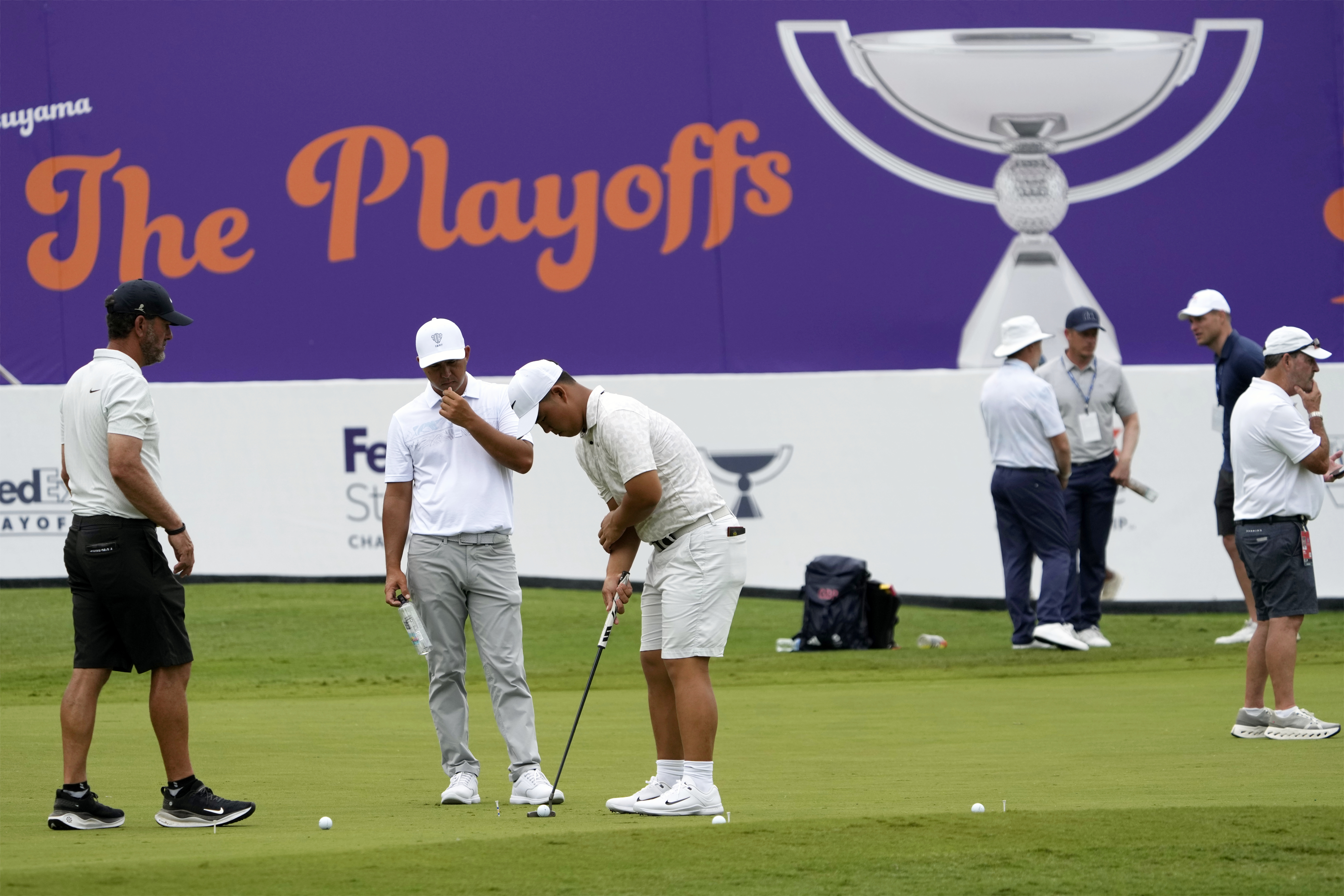 Players work on their game on the practice green at the St. Jude Championship golf tournament Wednesday, Aug. 14, 2024, in Memphis, Tenn. The tournament is scheduled to begin Thursday.