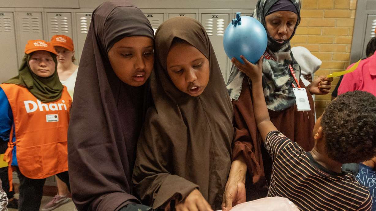 Families pick out backpacks during Utah Refugee Connection’s annual back-to-school event at Granite Park Junior High School in South Salt Lake on Aug. 6.