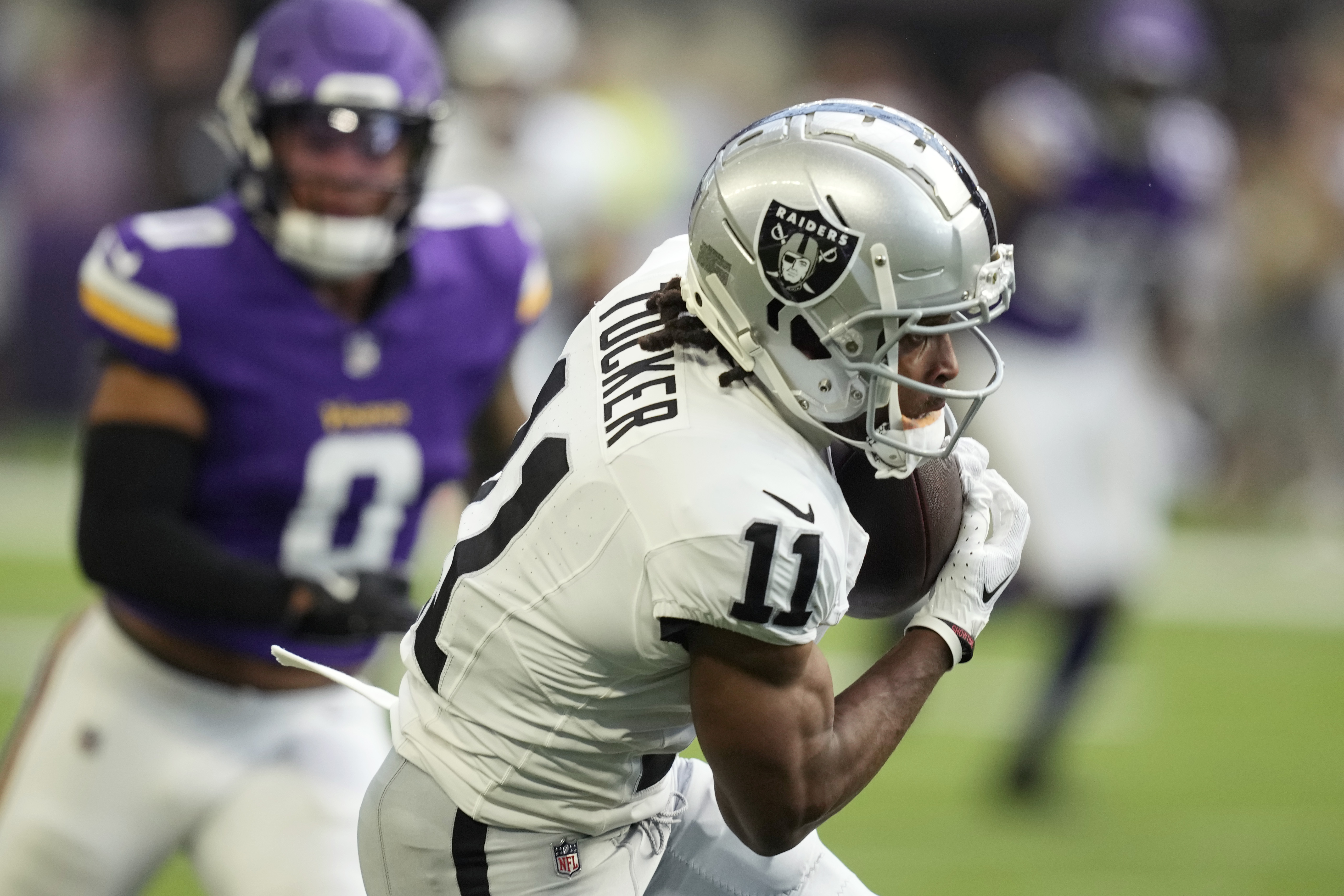 Las Vegas Raiders wide receiver Tre Tucker (11) makes a catch in front of Minnesota Vikings linebacker Ivan Pace Jr. (0) during the first half of an NFL football game Saturday, Aug. 10, 2024, in Minneapolis. 