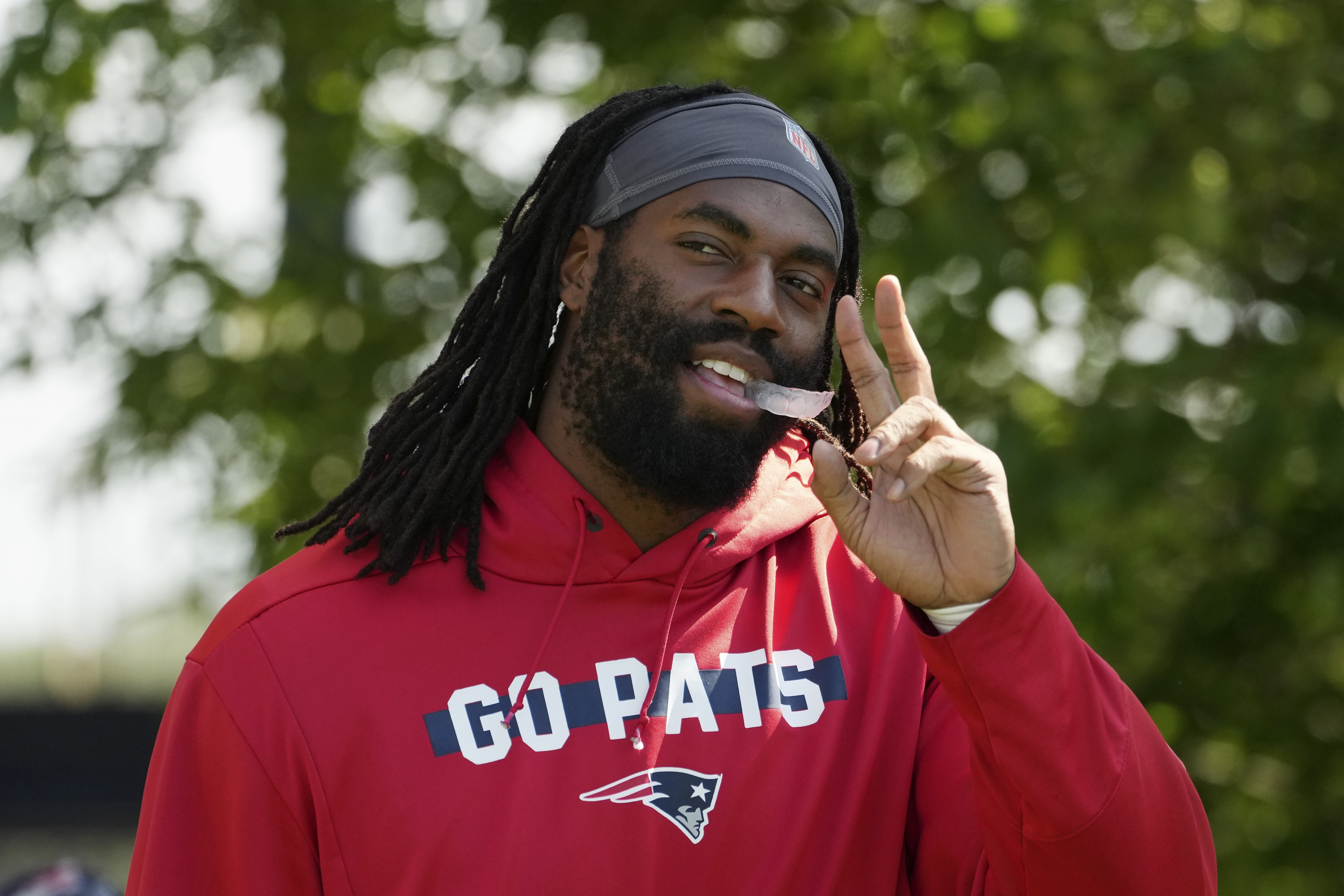 New England Patriots linebacker Matthew Judon walks onto the field during a joint NFL football practice with the Philadelphia Eagles, Tuesday, Aug. 13, 2024, in Foxborough, Mass.