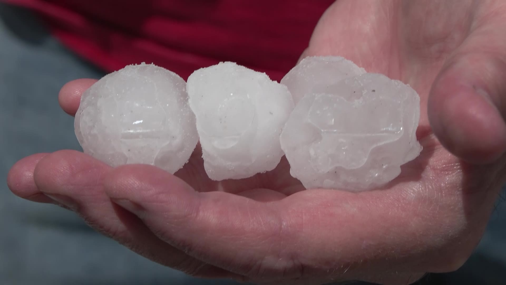 Steve Pocock holds golf ball-sized hail in his hand on Wednesday in Lehi.