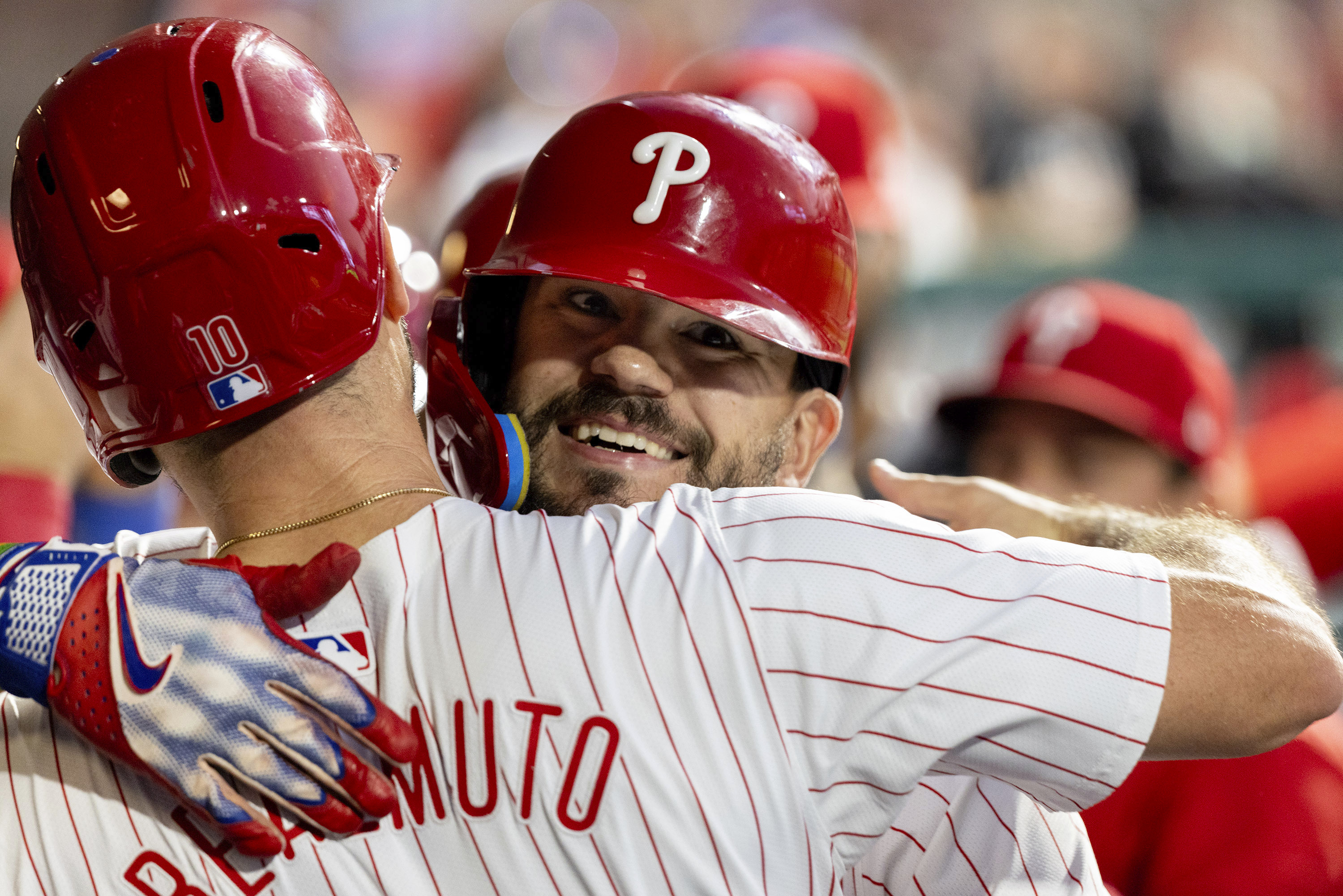 Philadelphia Phillies designated hitter Kyle Schwarber is embraced by J.T. Realmuto after hitting a grand slam during the fourth inning of a baseball game against the Miami Marlins, Wednesday, Aug. 14, 2024, in Philadelphia. 