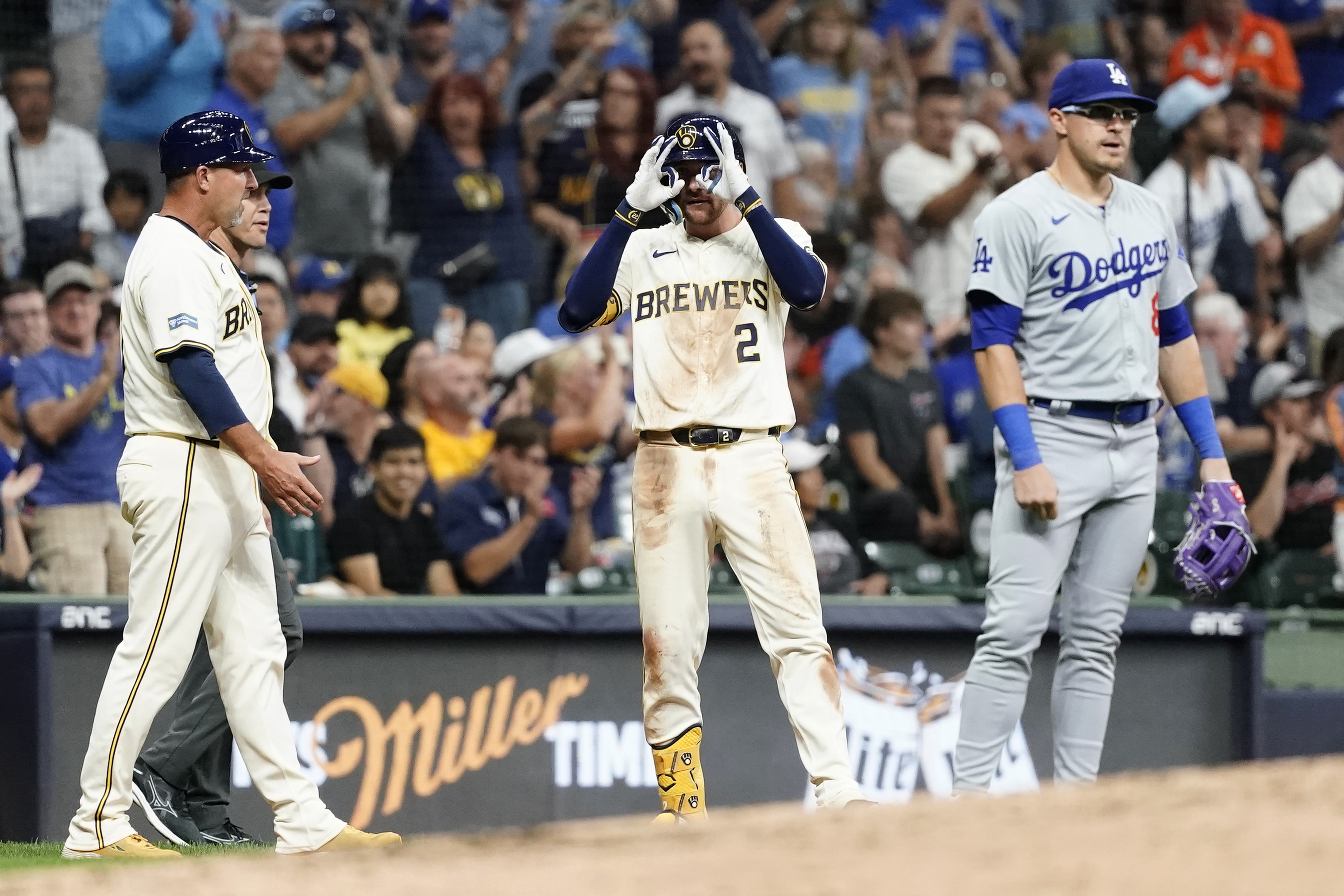 Milwaukee Brewers' Brice Turang (2) gestures after hitting an RBI-triple iin the second inning of a baseball game against the Los Angeles Dodgers, Wednesday, Aug. 14, 2024, in Milwaukee. 