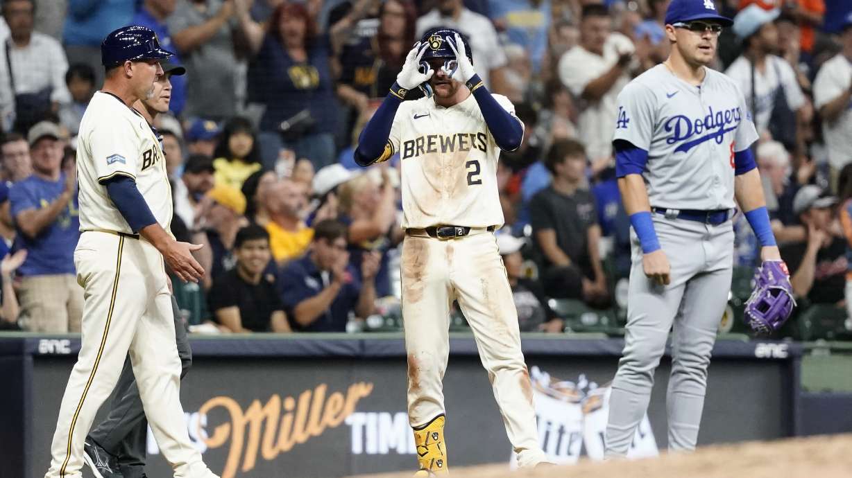 Milwaukee Brewers' Brice Turang (2) gestures after hitting an RBI-triple iin the second inning of a baseball game against the Los Angeles Dodgers, Wednesday, Aug. 14, 2024, in Milwaukee.