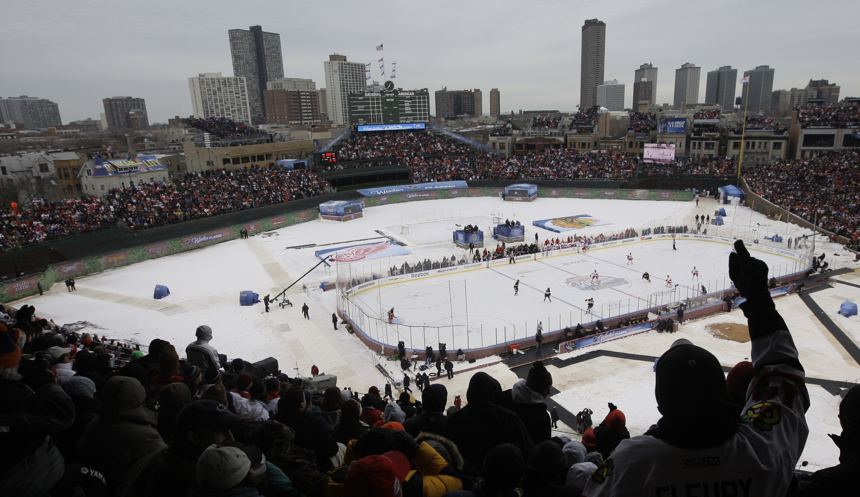 FILE - Fans cheer during the first period of the NHL Winter Classic hockey game between the Detroit Red Wings and the Chicago Blackhawks at Wrigley Field in Chicago, Jan. 1, 2009. 